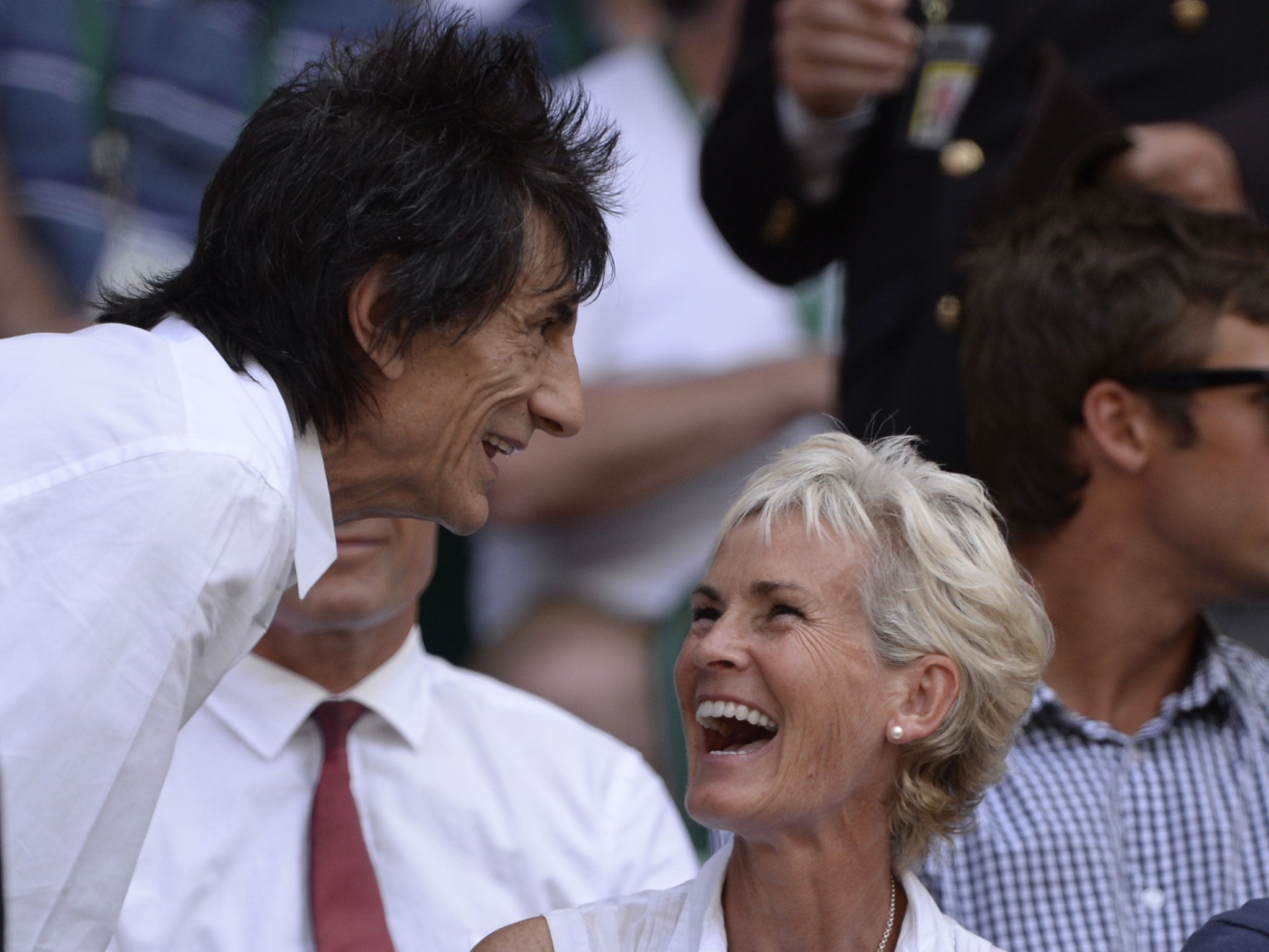 Judy Murray, mother of Britain's Andy Murray (R) laughs as she talks with Ronnie Wood of British rock band The Rolling Stones in the crowd as she prepares to watch the men's singles final between Serbia's Novak Djokovic and Britain's Andy Murray on day thirteen of the 2013 Wimbledon Championships tennis tournament at the All England Club in Wimbledon, southwest London, on July 7, 2013.