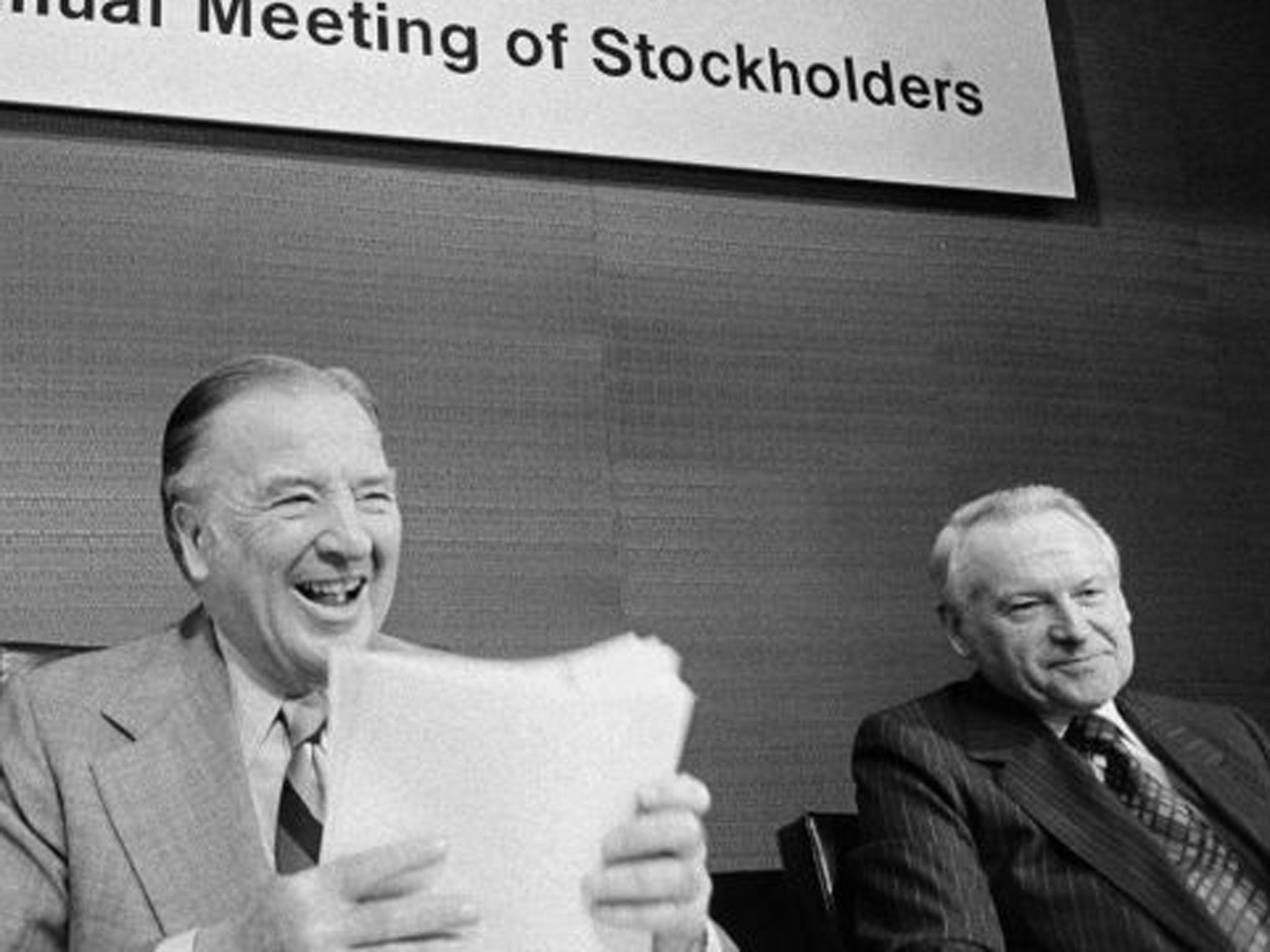 Caldwell, right, faces Ford shareholders with Henry Ford II in Detroit in 1977