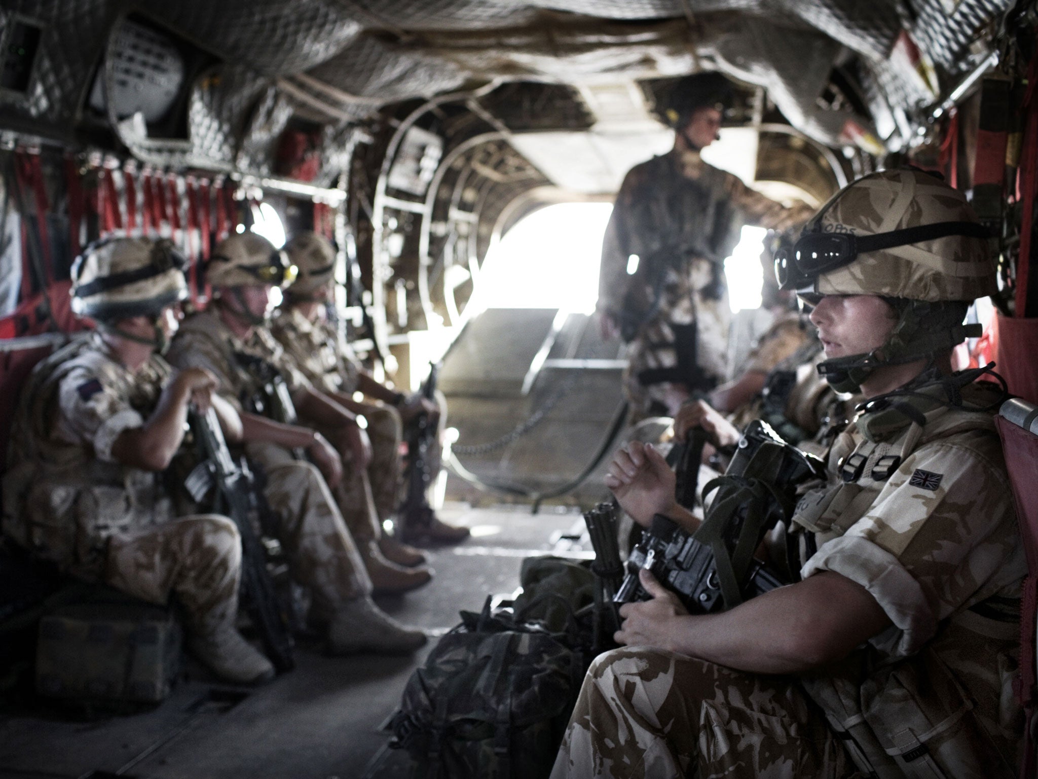 British Army soldiers from the Quick Reaction Force travel in the helicopter to protect the British Army Medical Emergency Response team from the UK Med Group as they go to the front line to collect a casualty on June 11, 2007