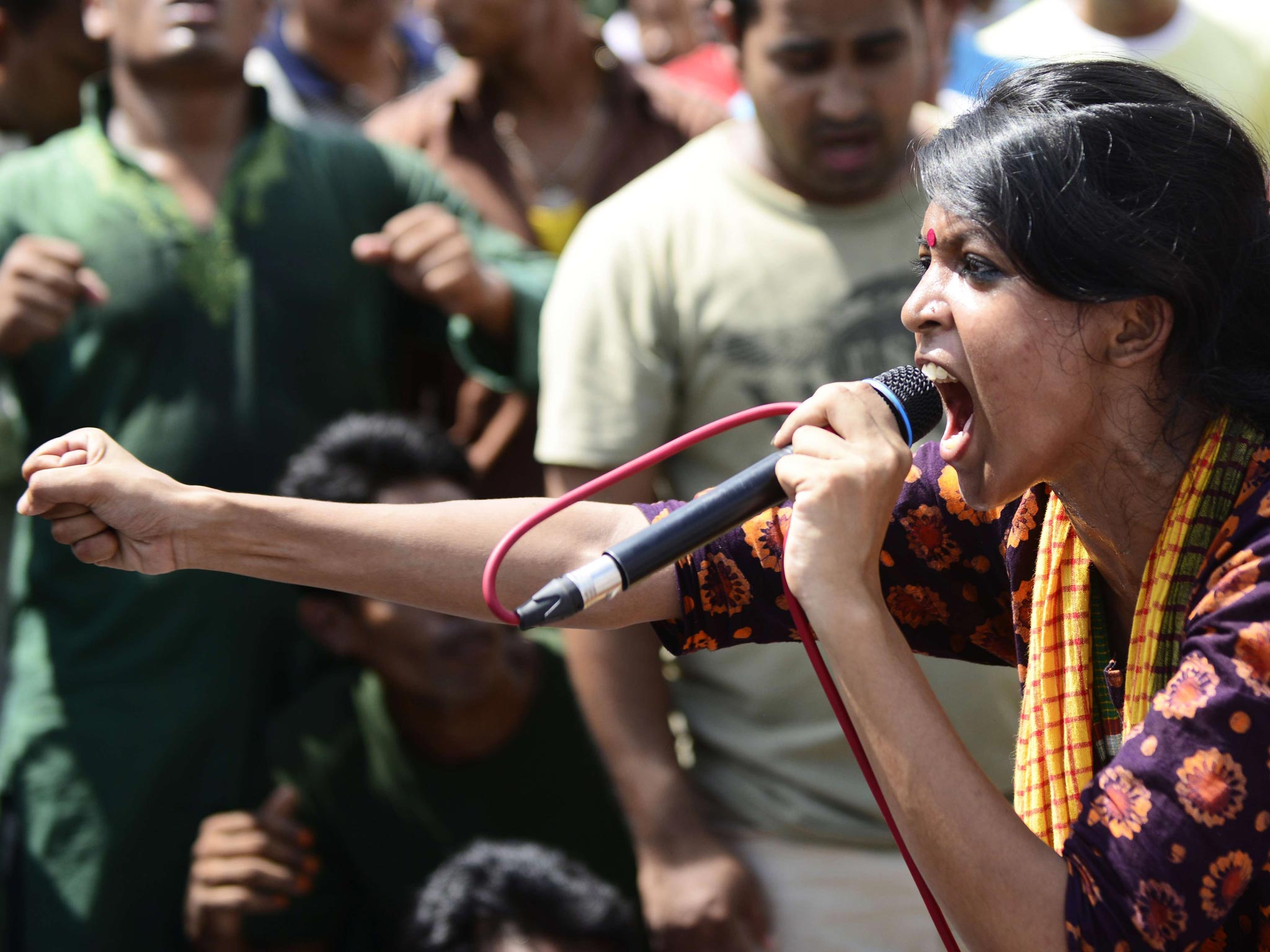 A Bangladeshi social activist shouts slogans against Ghulam Azam, whom she and other protesters wished to be sentenced to death, outside a court in Dhaka