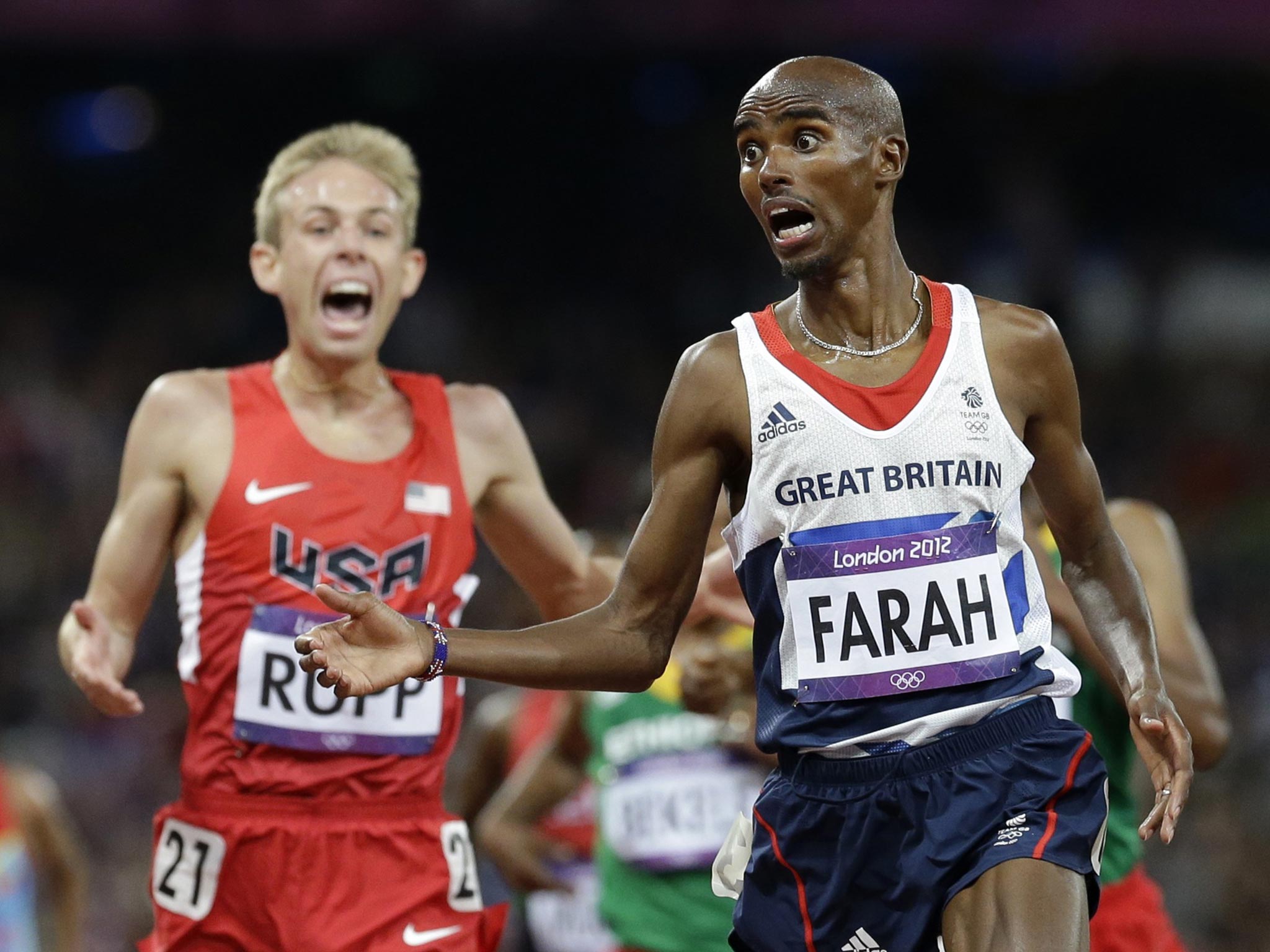 Mo Farah crosses the finish line to win gold ahead of United States' Galen Rupp