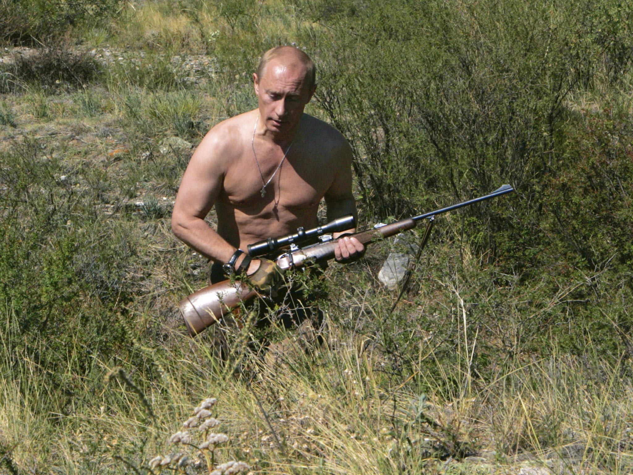 Vladimir Putin carries a hunting rifle during his trip in Ubsunur Hollow in the Siberian Tyva region (also referred to as Tuva), on the border with Mongolia, Russia