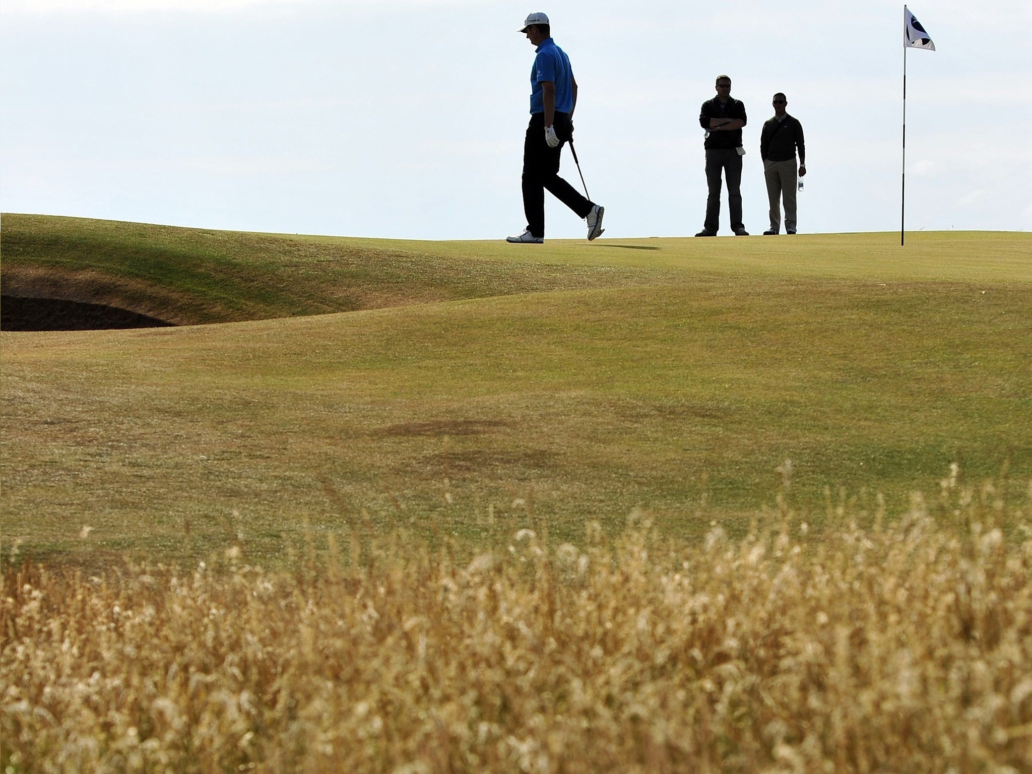 Justin Rose walks on the seventh green during a practice round