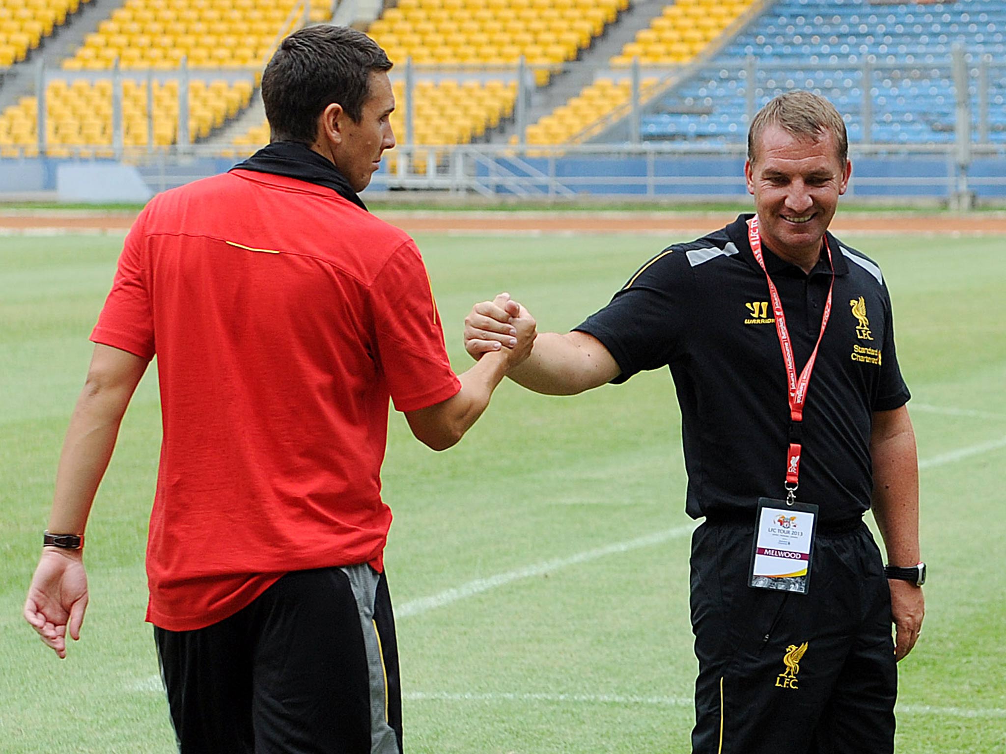 Brendan Rodgers manager of Liverpool shakes hands with Stewart Downing