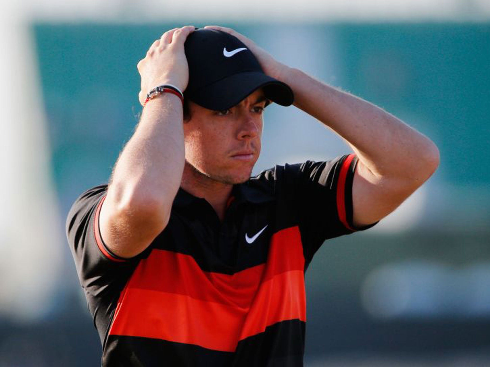 Rory McIlroy walks off the 18th green after finishing his round of 75