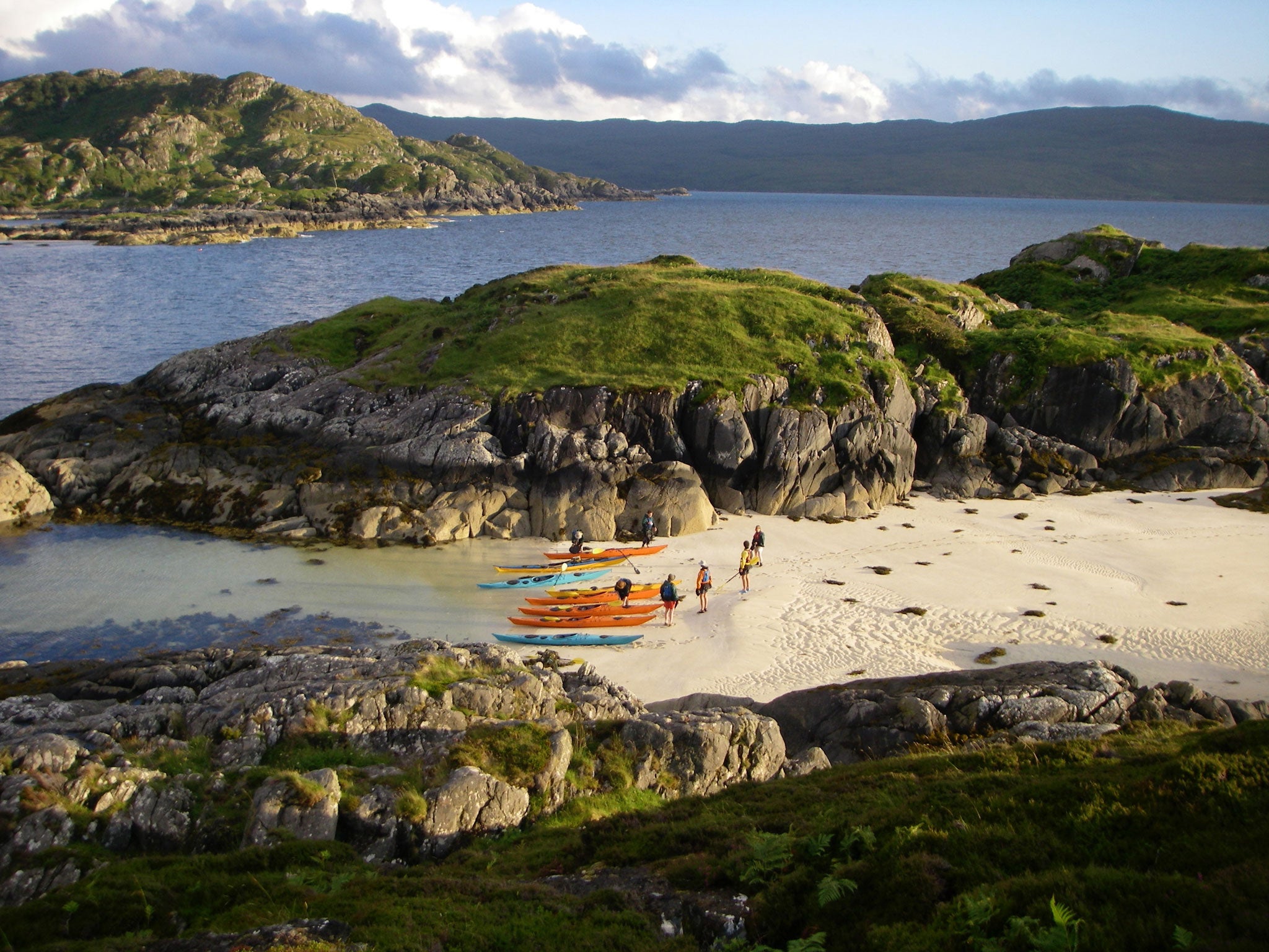 Safe and sound: Kayakers catch their breath on the shores of the tidal island of Eilean Shona in Loch Moidart