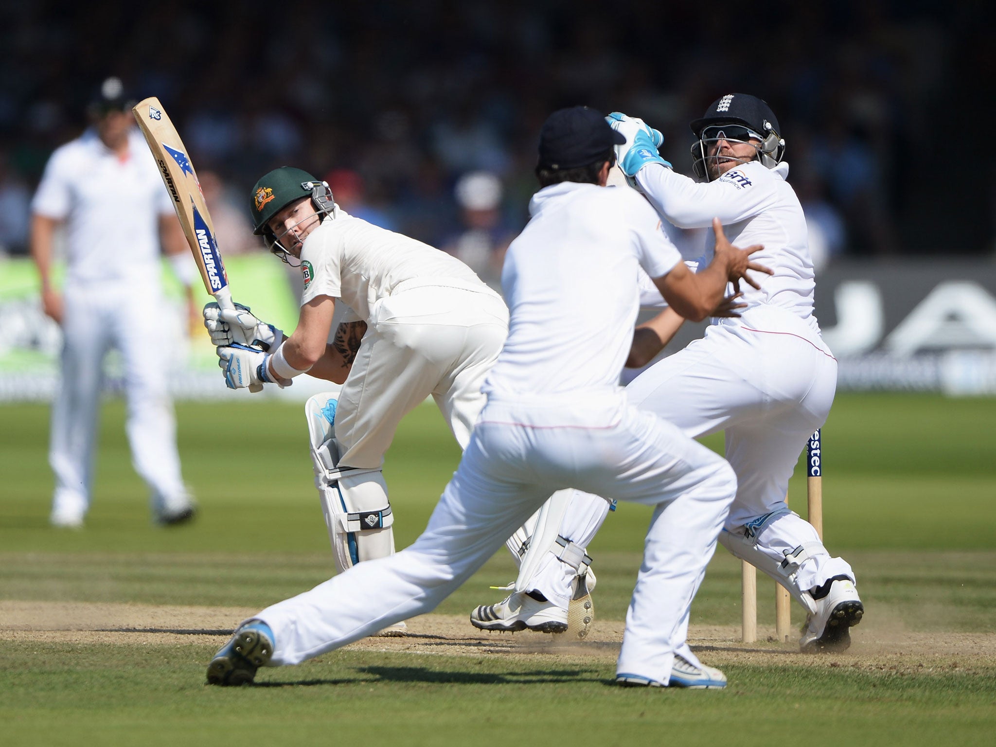 Michael Clarke can only watch as he is caught by opposing captain Alastair Cook at Lord’s