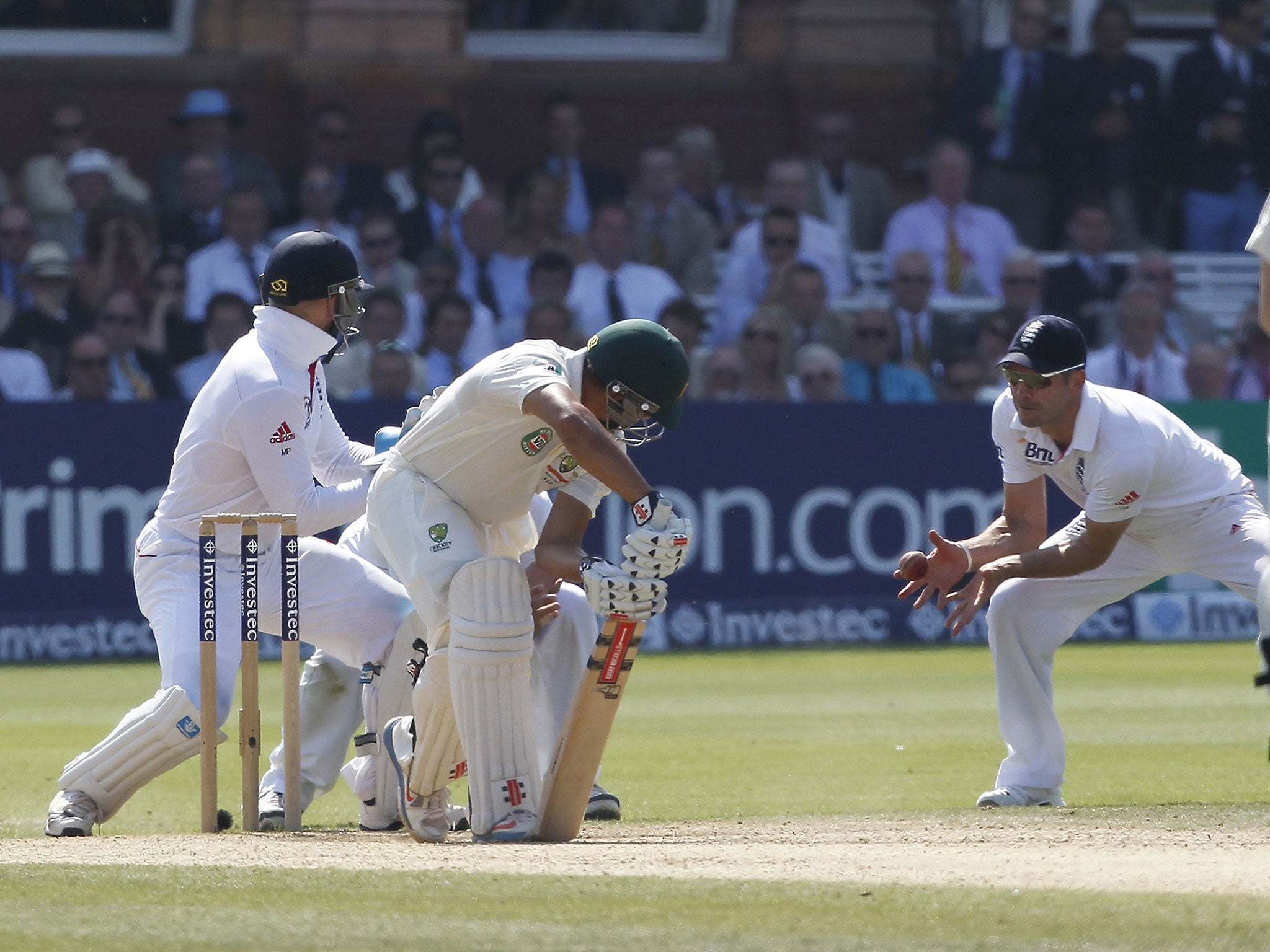 Usman Khawaja, 2nd left, is caught by Jimmy Anderson, right, off Joe Root while