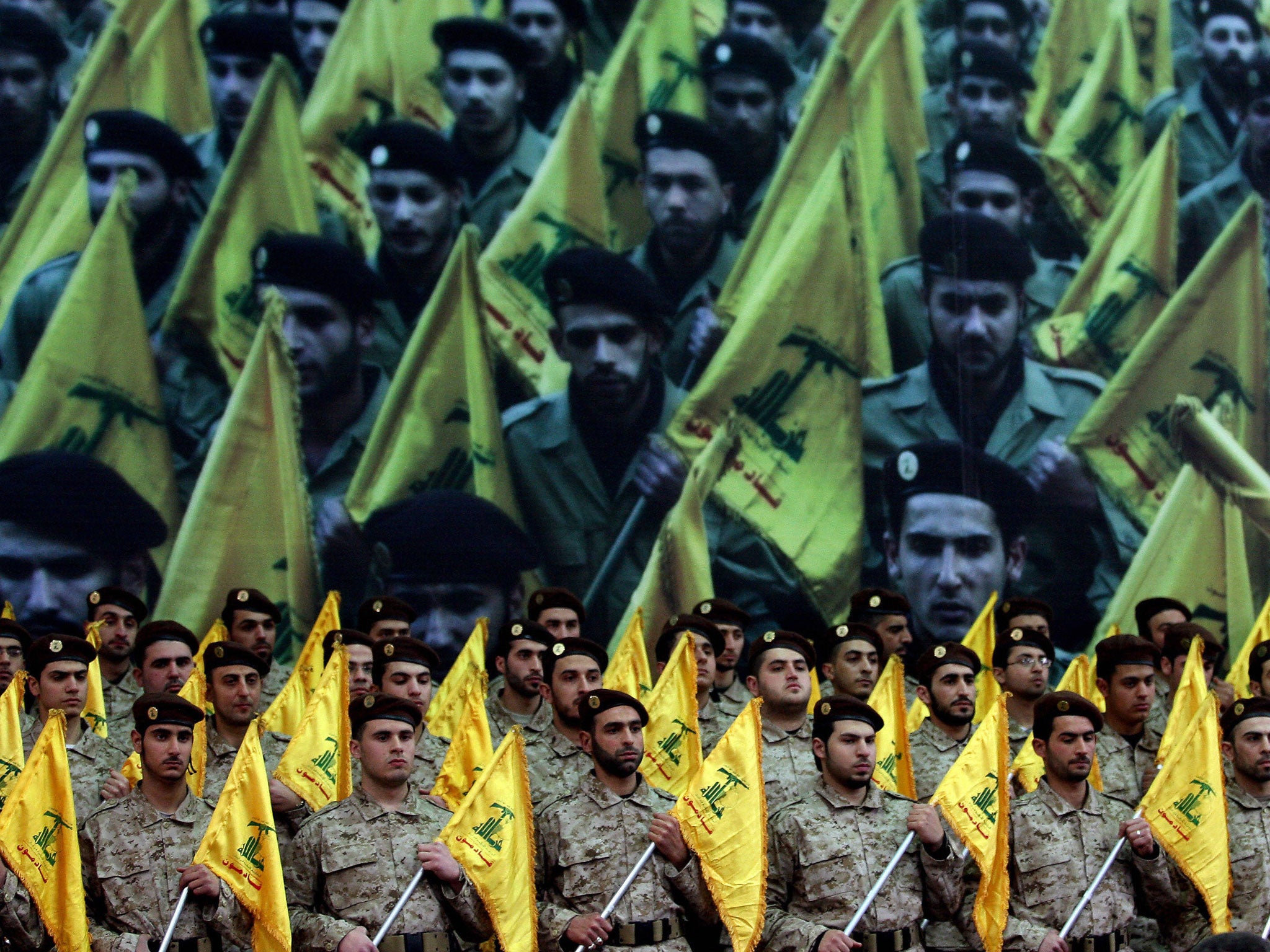 Shiite Muslims Hezbollah militants stand to attention