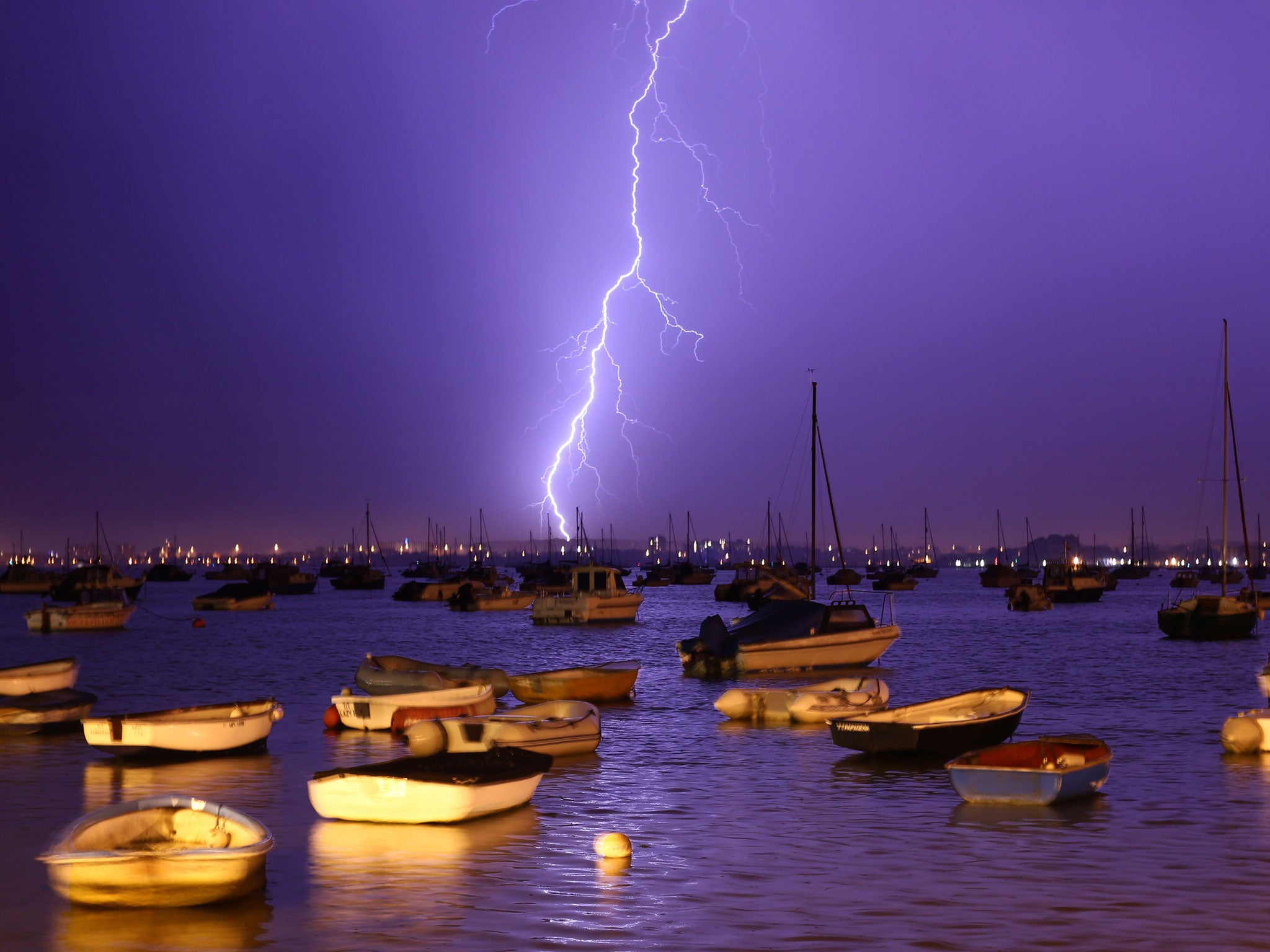 Lightning at Poole Harbour; violent thunderstorms are expected over weekend getaway