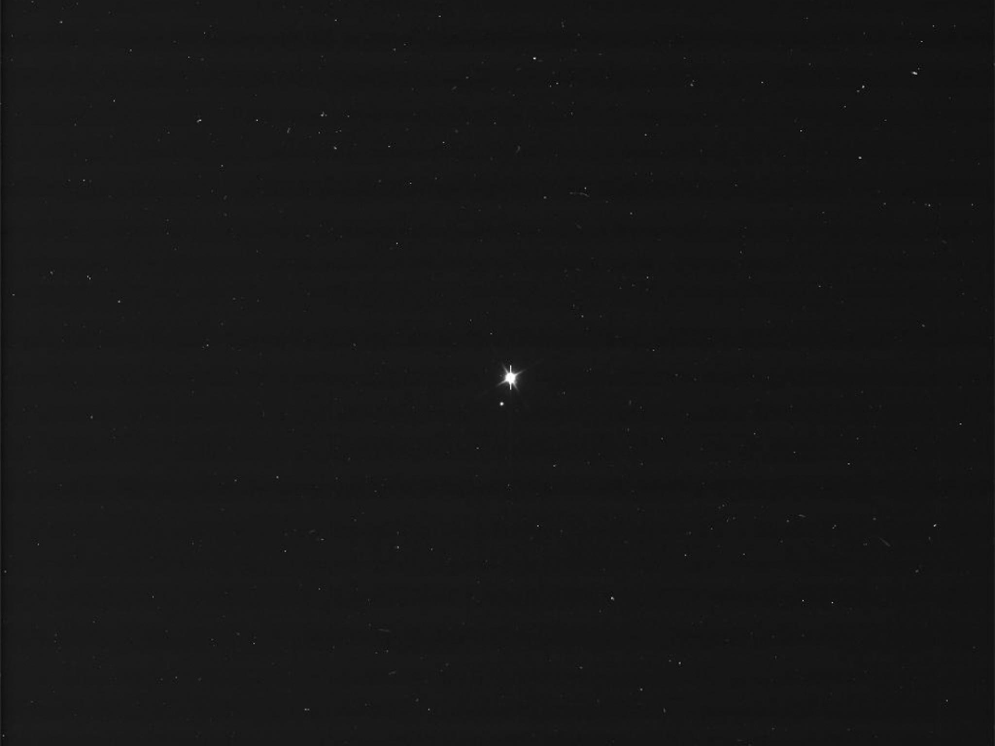 An image of Earth and the moon taken by NASA's Cassini spacecraft