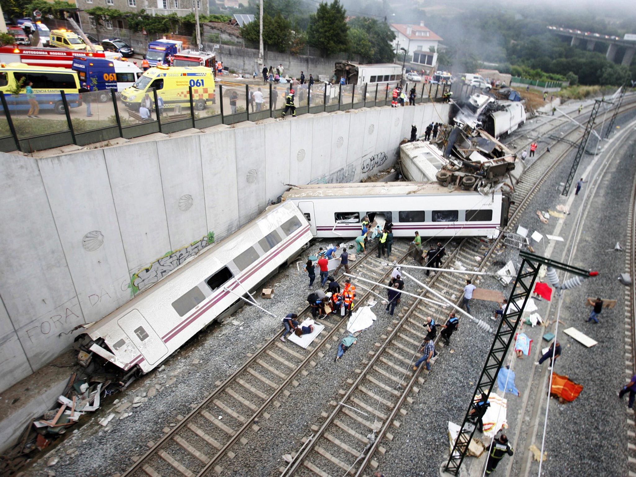 Derailed cars at the site of a train accident near the city of Santiago de Compostela