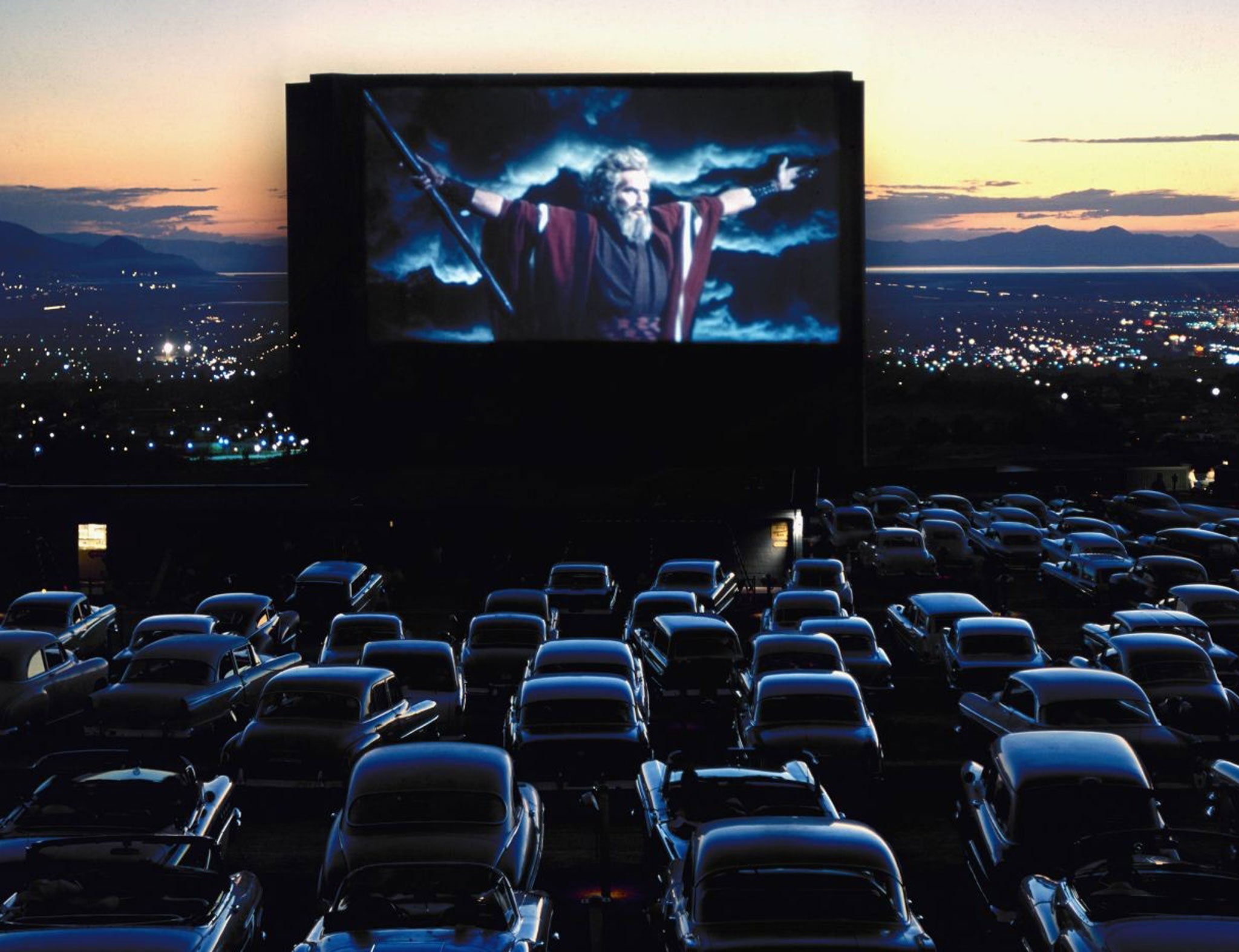 Promised land: Charlton Heston as Moses, leading the faithful in their gas-guzzlers to the latest blockbuster in the 1950s