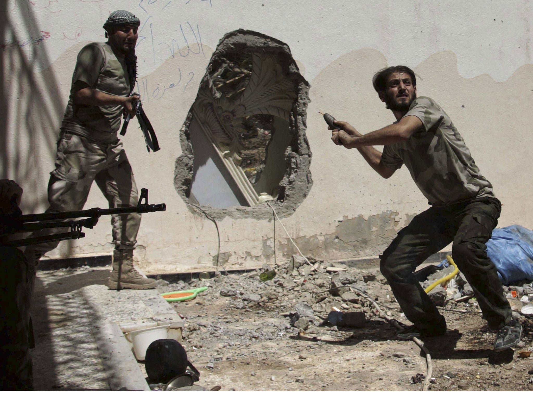 A Free Syrian Army fighter throwing an improvised bomb