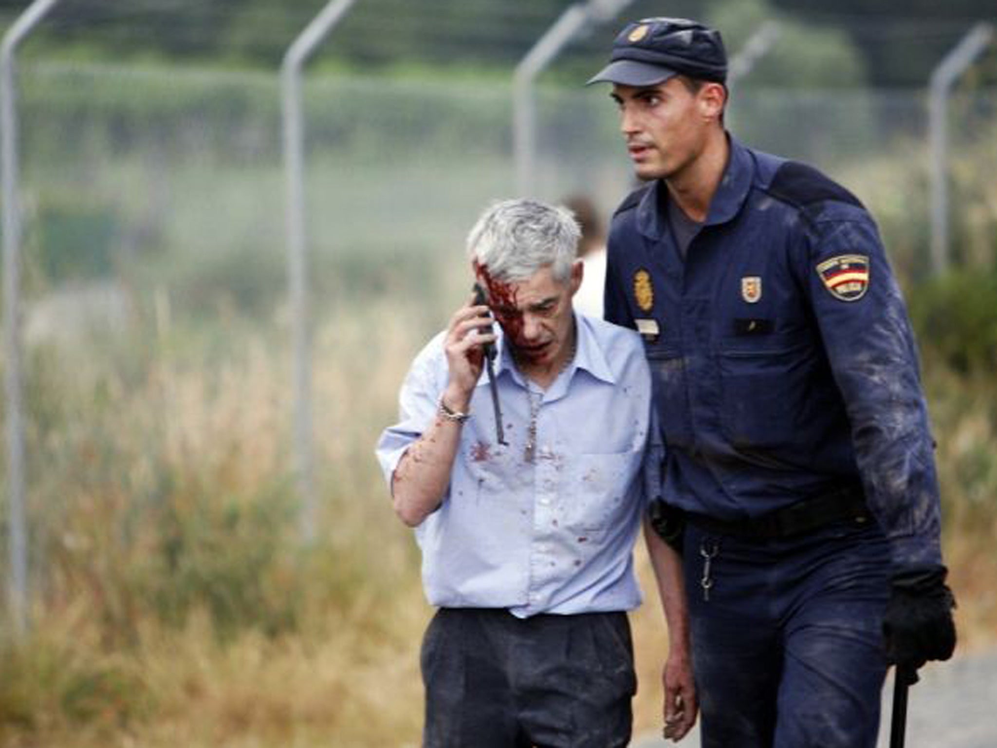 The train driver Francisco Jose Garzon is helped away EPA