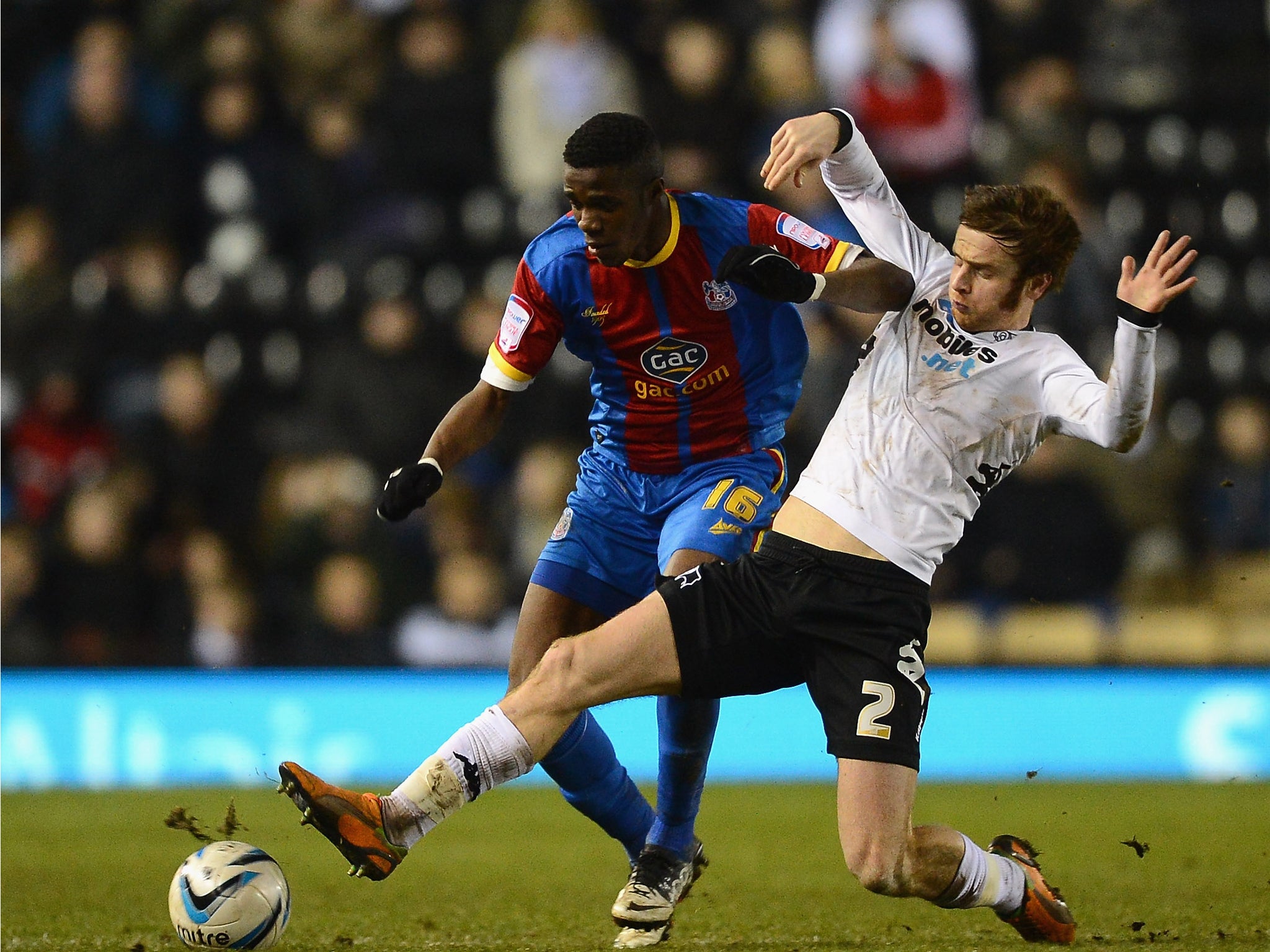 John Brayford (r) tackles Crystal Palace winger Wilfried Zaha (l)