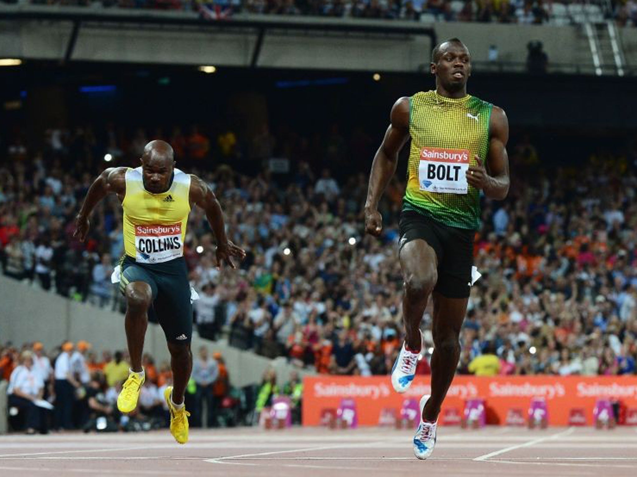 Usain Bolt crosses the line first ahead of Kim Collins