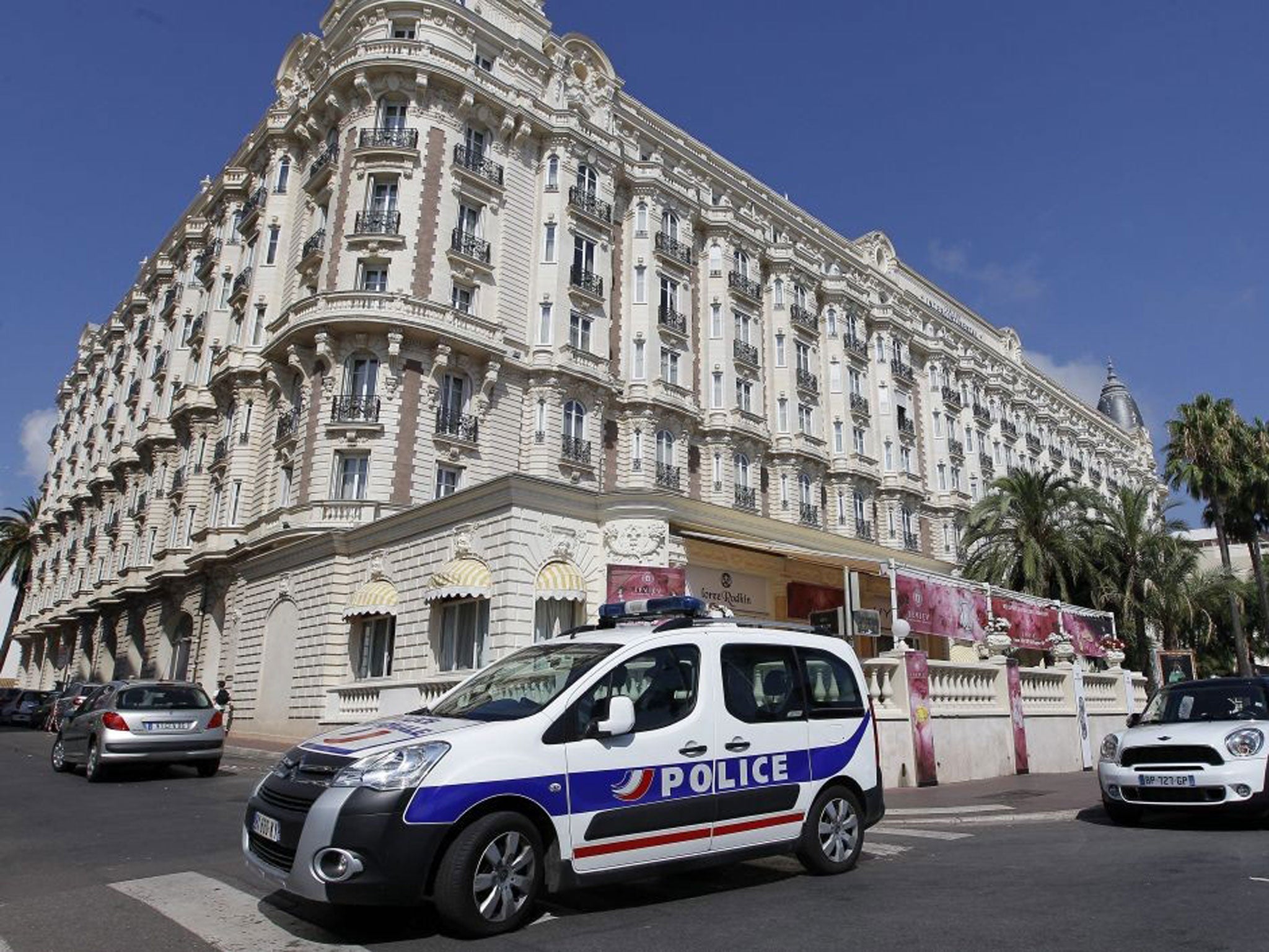 A police car stands outside the Carlton Intercontinental Hotel in Cannes