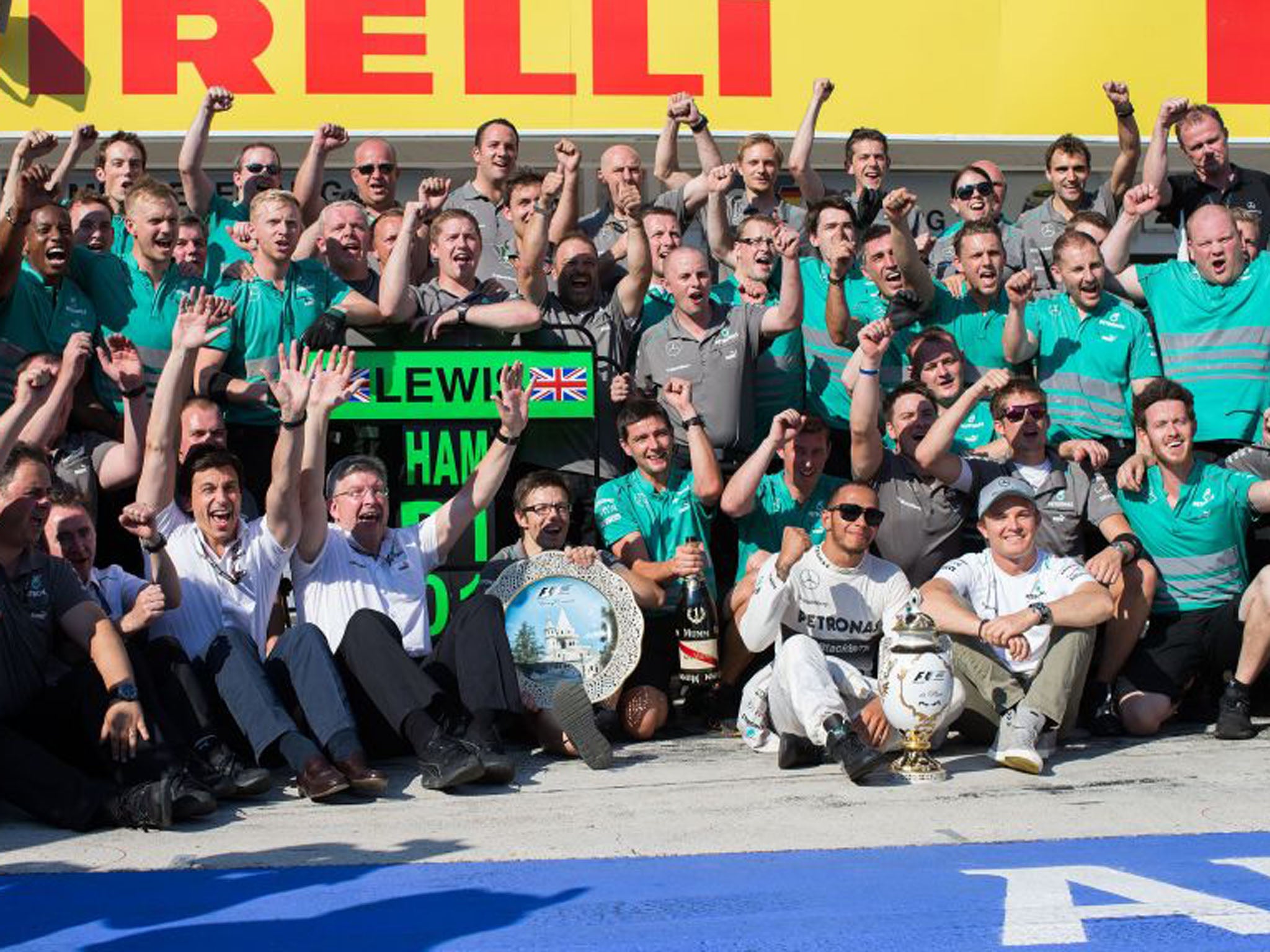 Lewis Hamilton, centre, celebrates with his Mercedes team following his first win for the outfit (Peter J Fox/Getty Images)