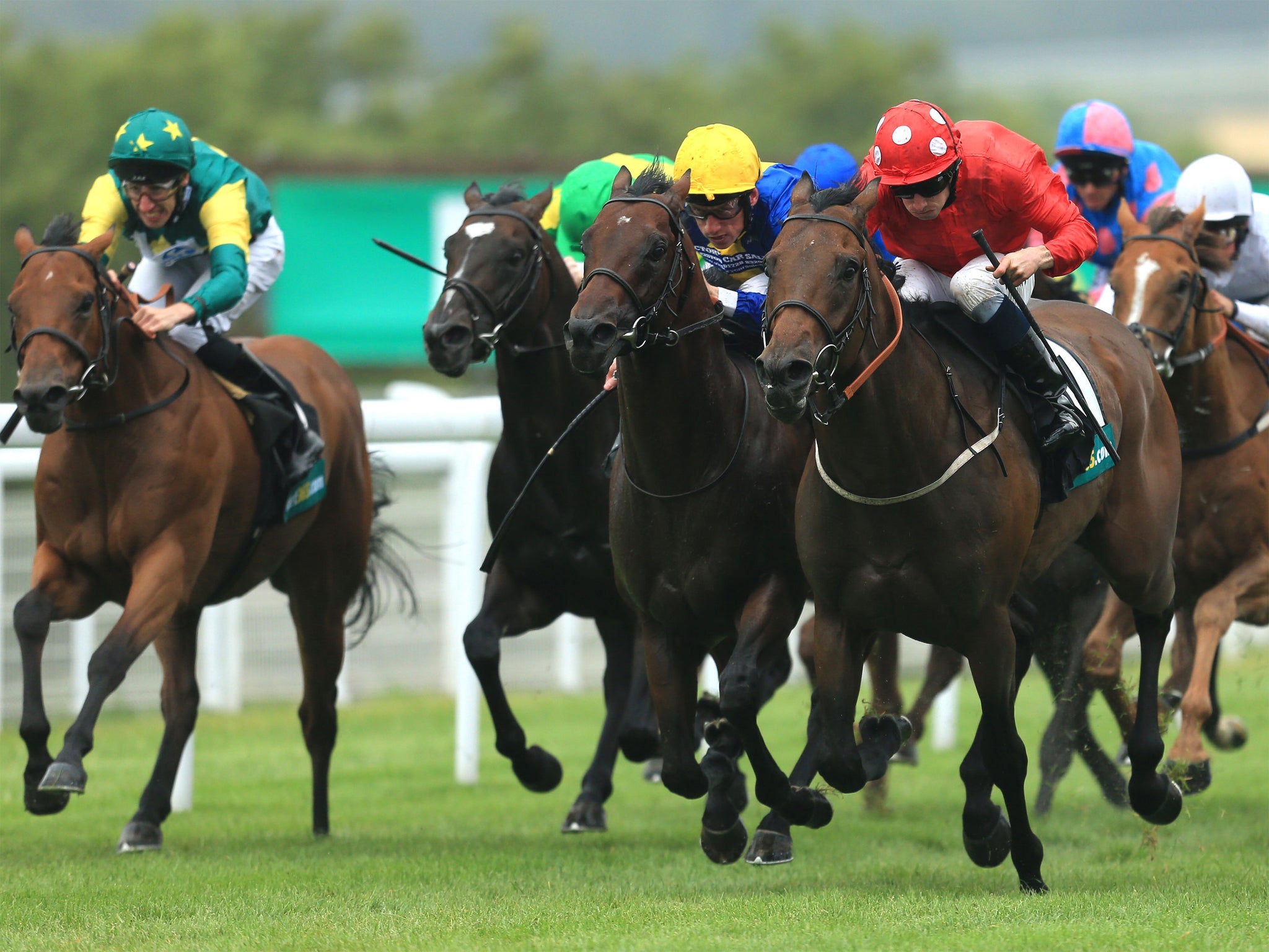 Ryan Moore (red) delivers Garswood late to land the Lennox Stakes