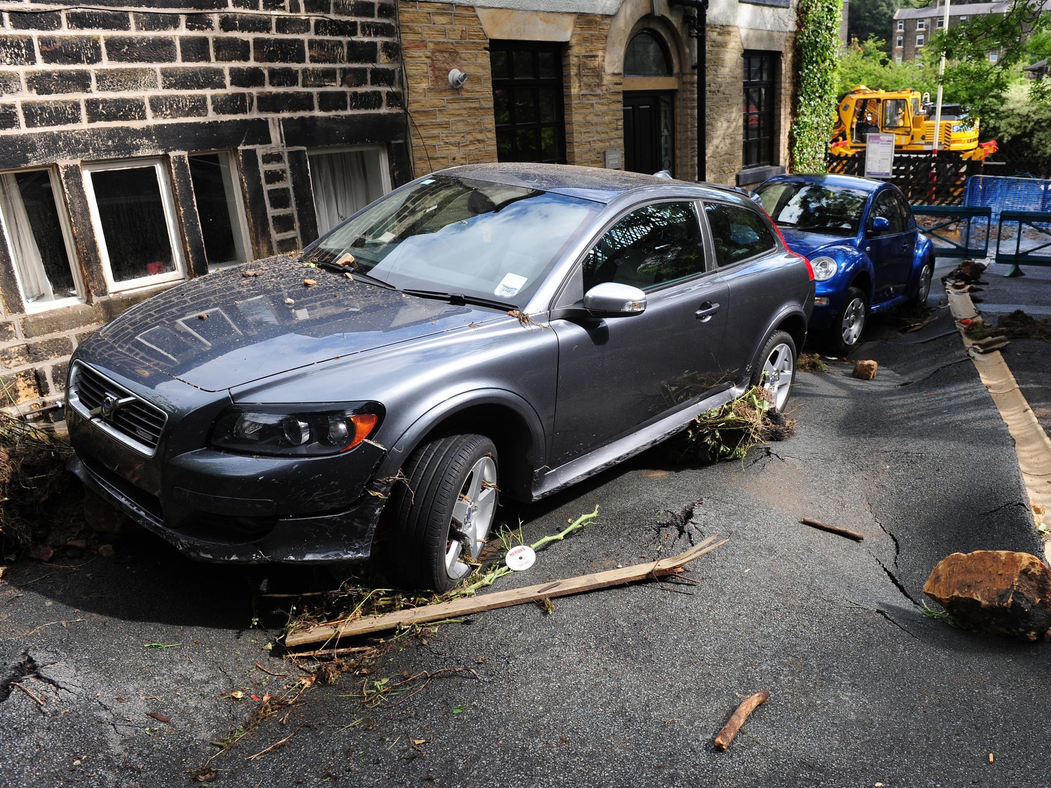Damaged cars and debris left by flash floods in Walsden, near Todmorden, West Yorkshire
