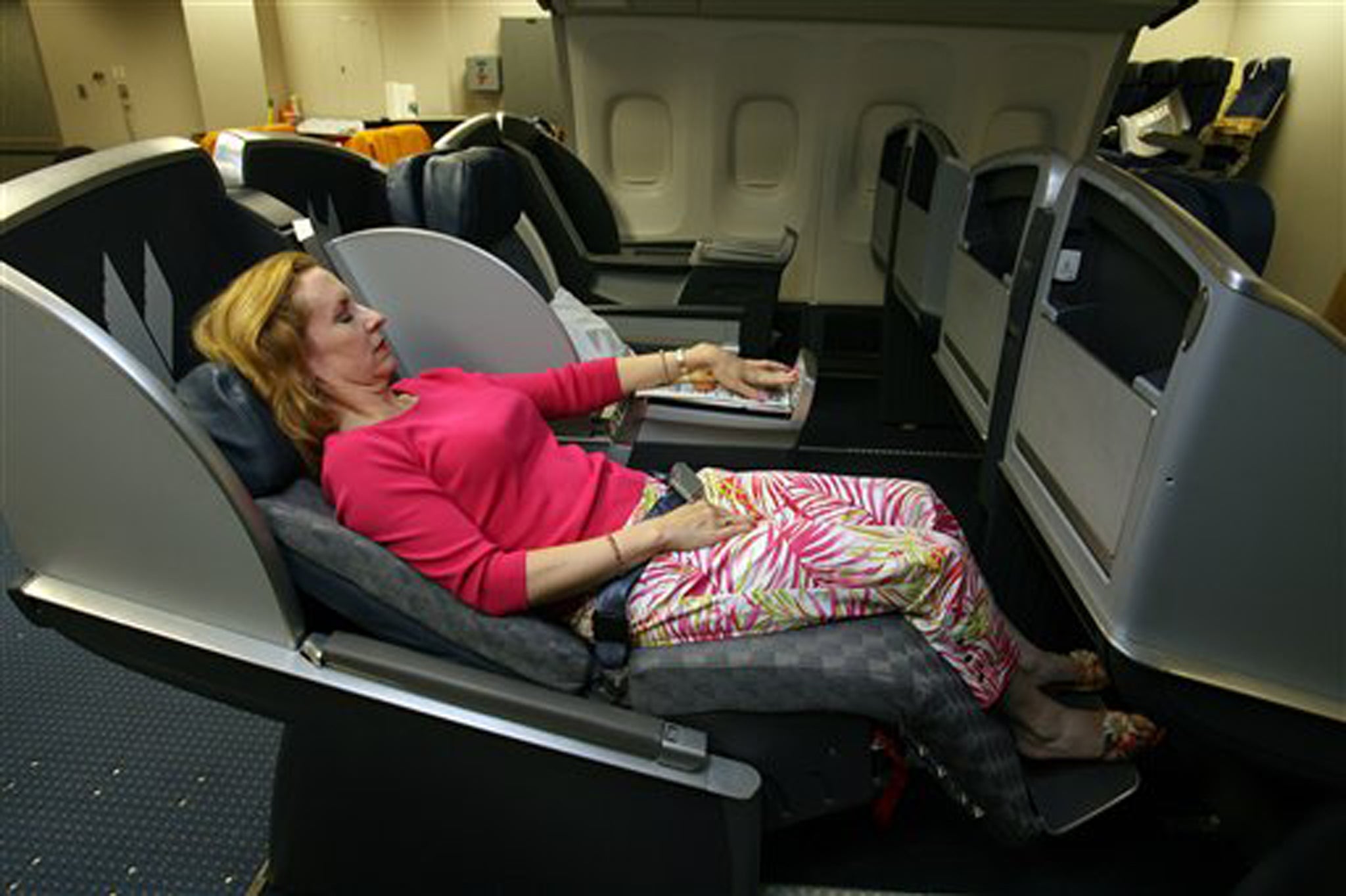 A passenger enjoys the in-flight entertainment