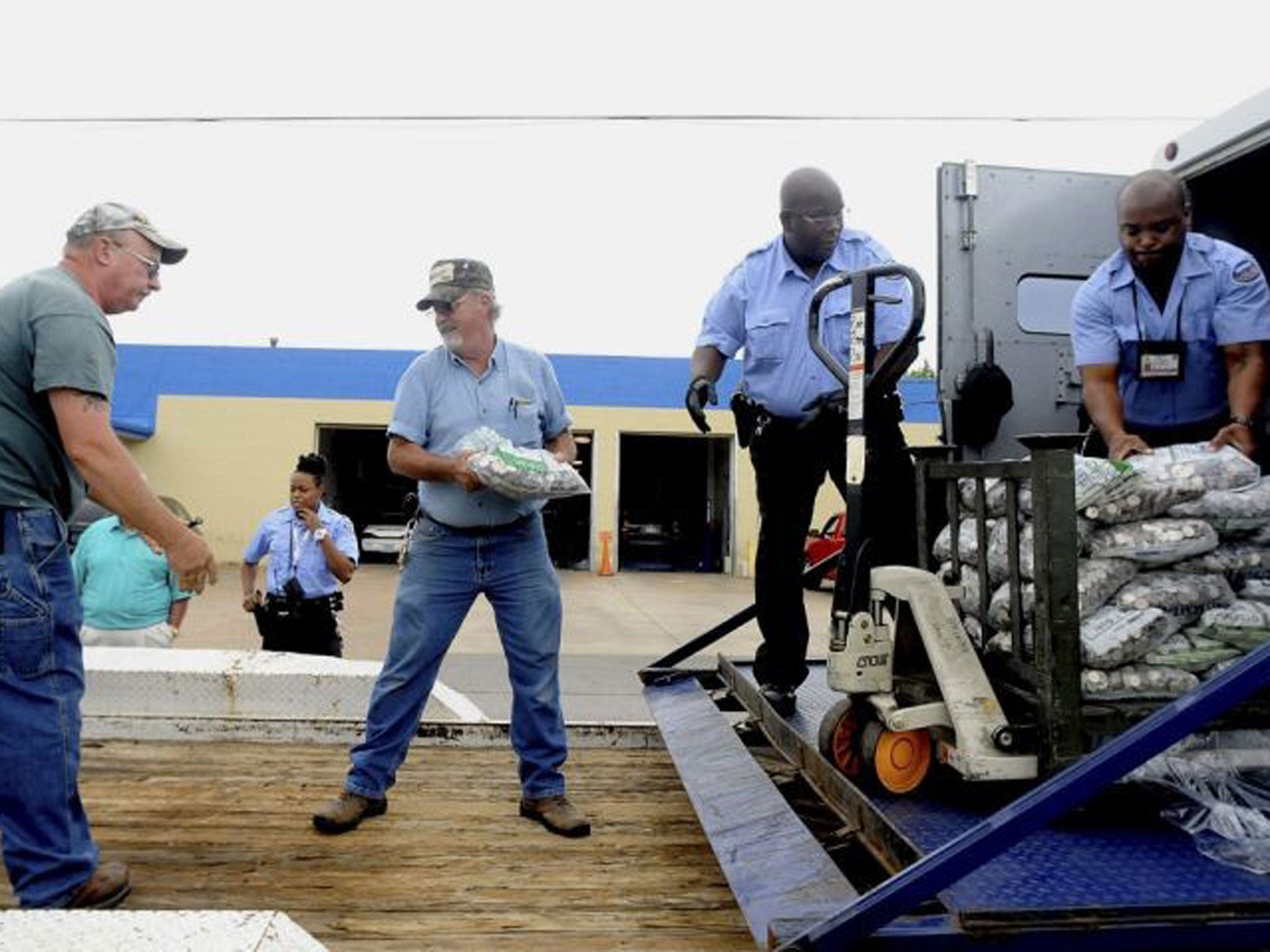 The coins were being delivered to two local law firms by Roger Herrin, of Harrisburg, Ill., who was paying off a portion of a court-ordered legal settlement with nearly four tons of quarters