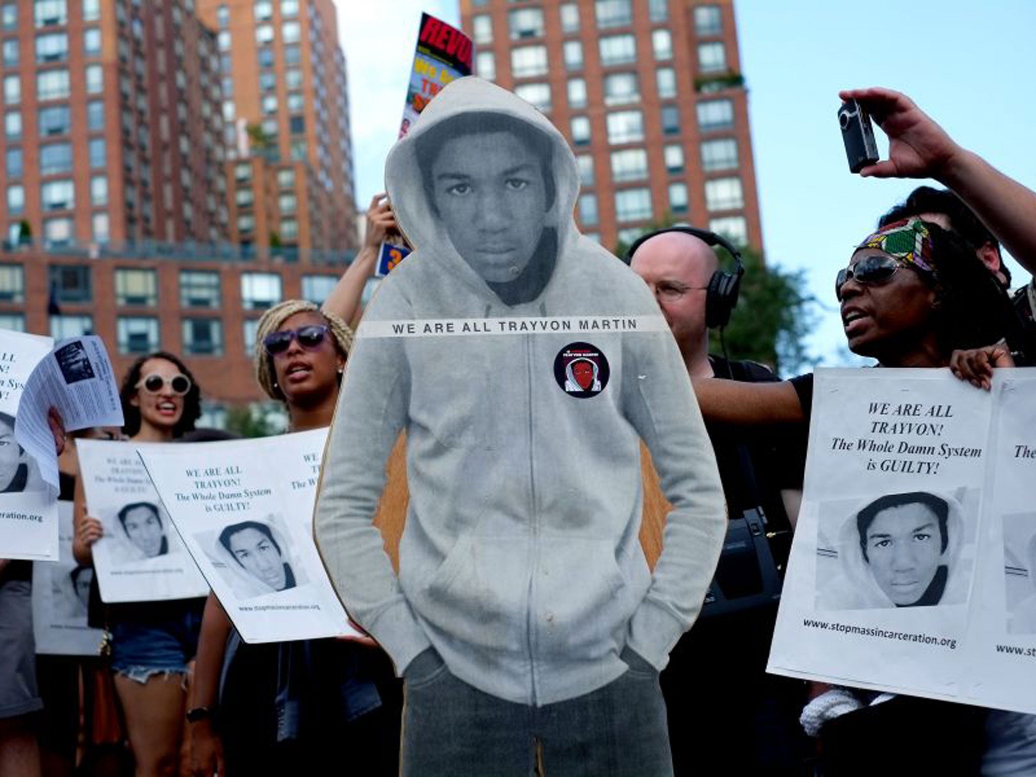 Activists carrying Trayvon Martin’s image protest in New York against the acquittal