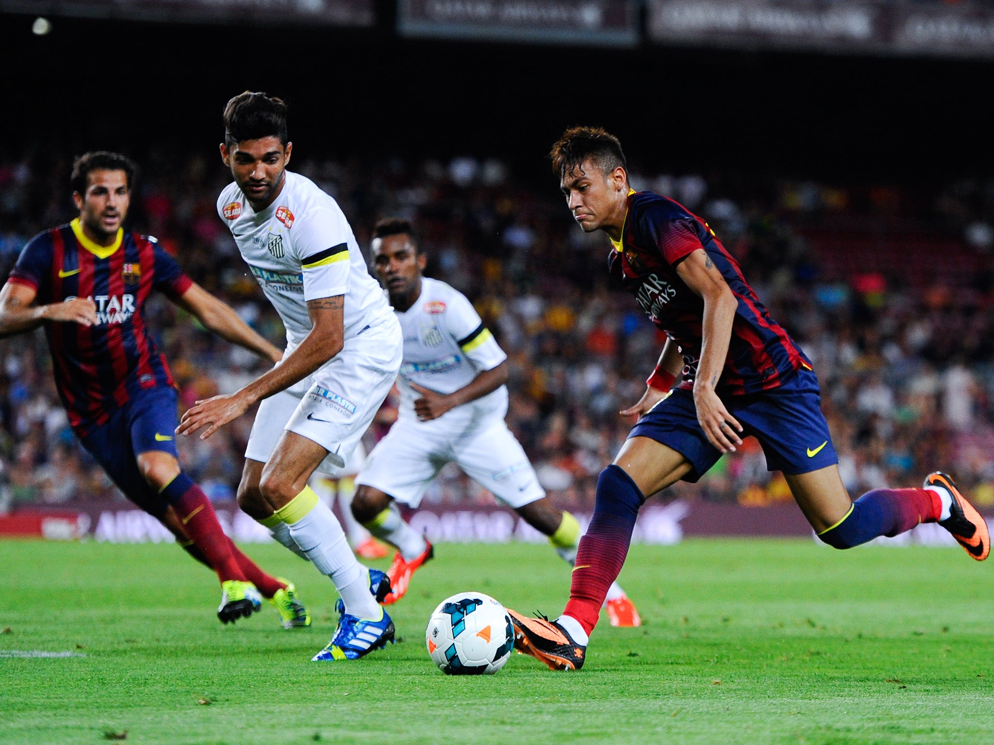 Neymar shows the Nou Camp crowd what he can do as he charges forward against his former club Santos