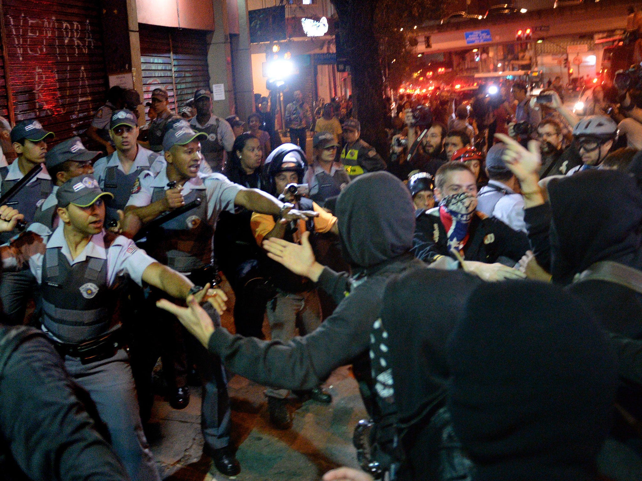 Protesters demonstrating against Amarildo de Souza’s disappearance clash with police