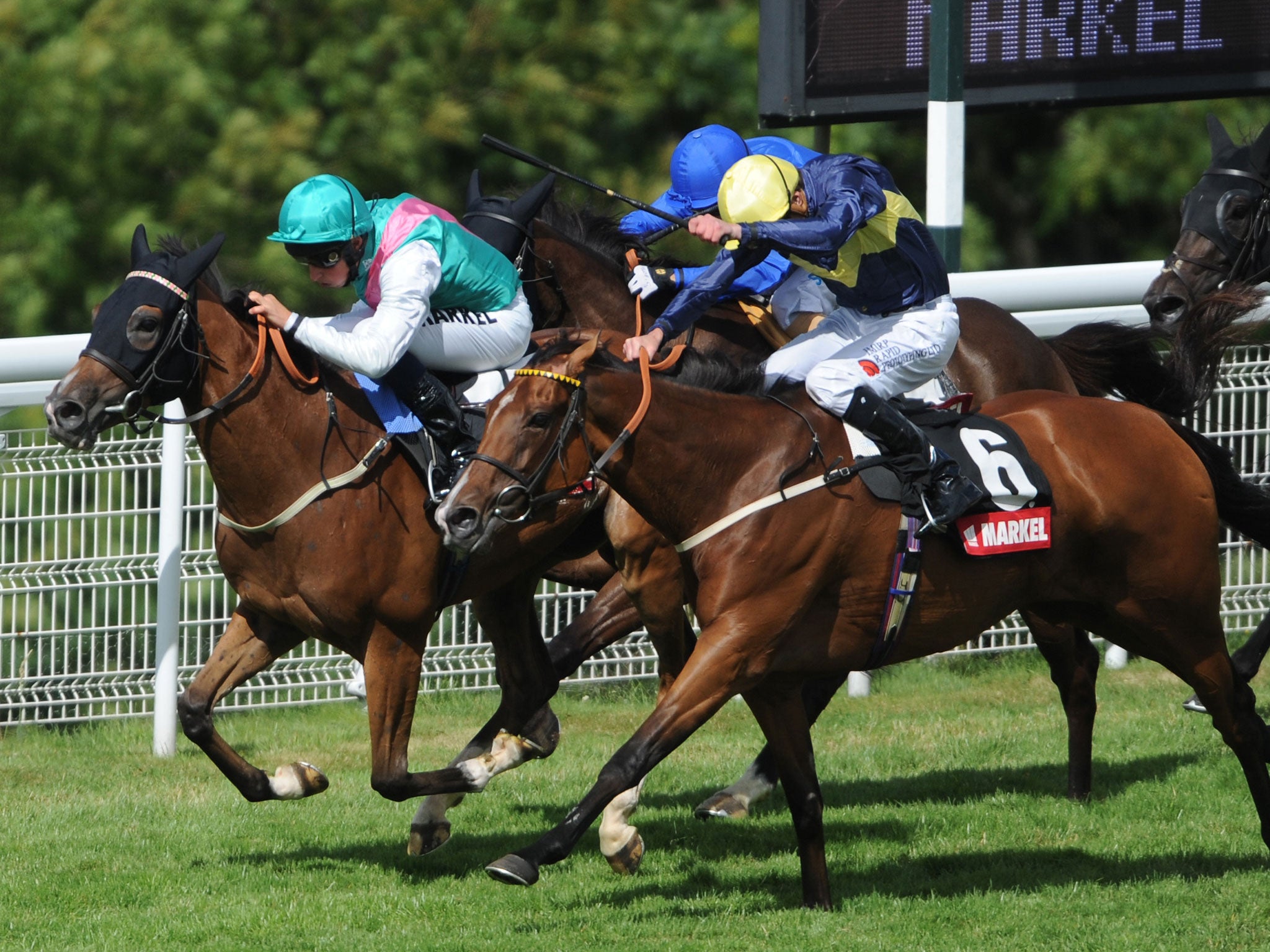 Winsili, left, edges home to take the Nassau Stakes at Goodwood