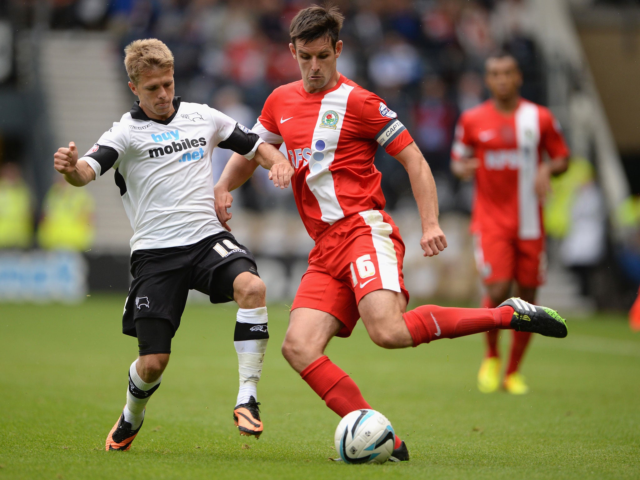 Derby’s Jamie Ward, left, challenges Scott Dann, right, of Blackburn