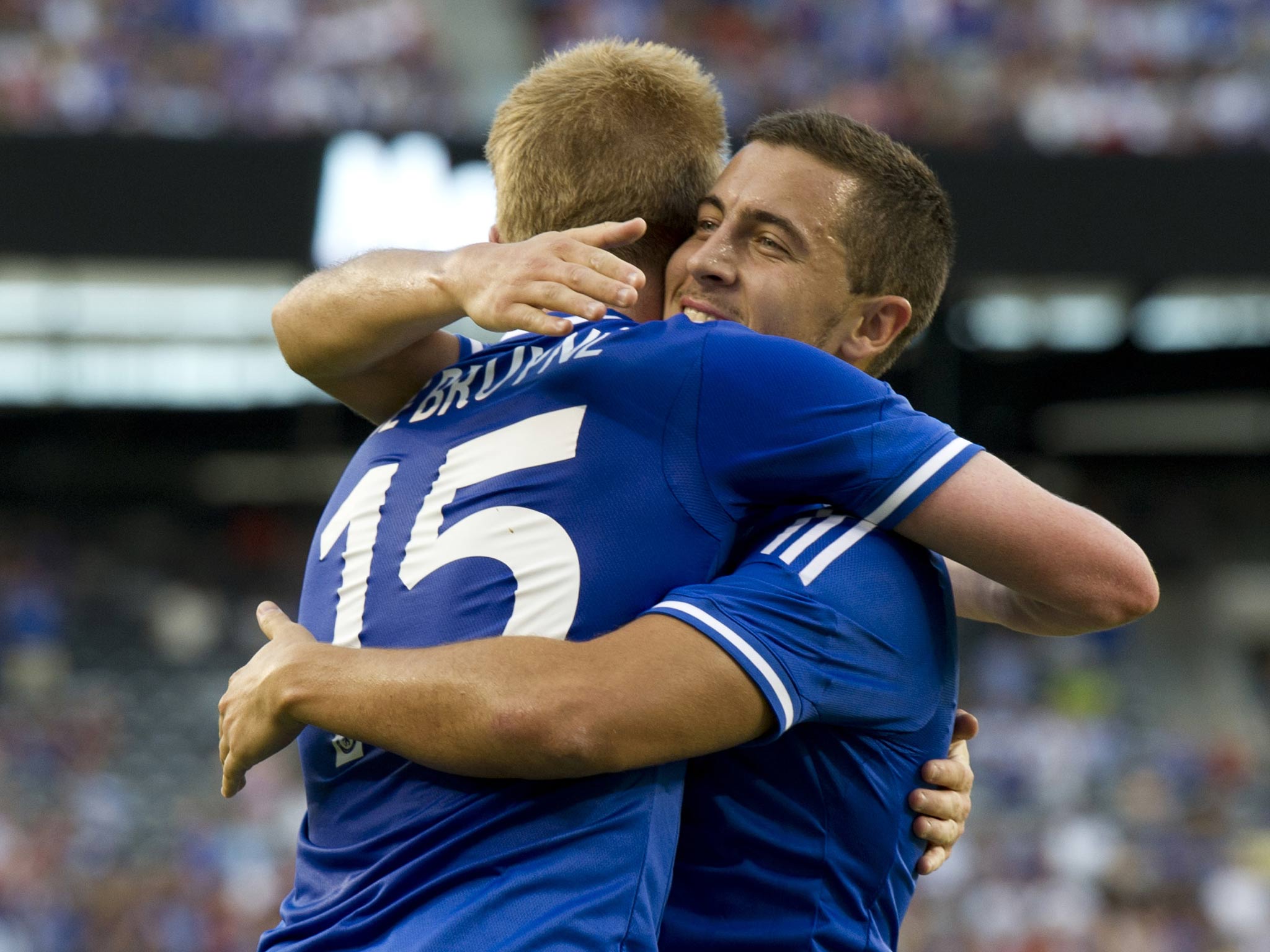 Kevin De Bruyne gets a hug from teammate Eden Hazard as they celebrate his goal against AC Milan