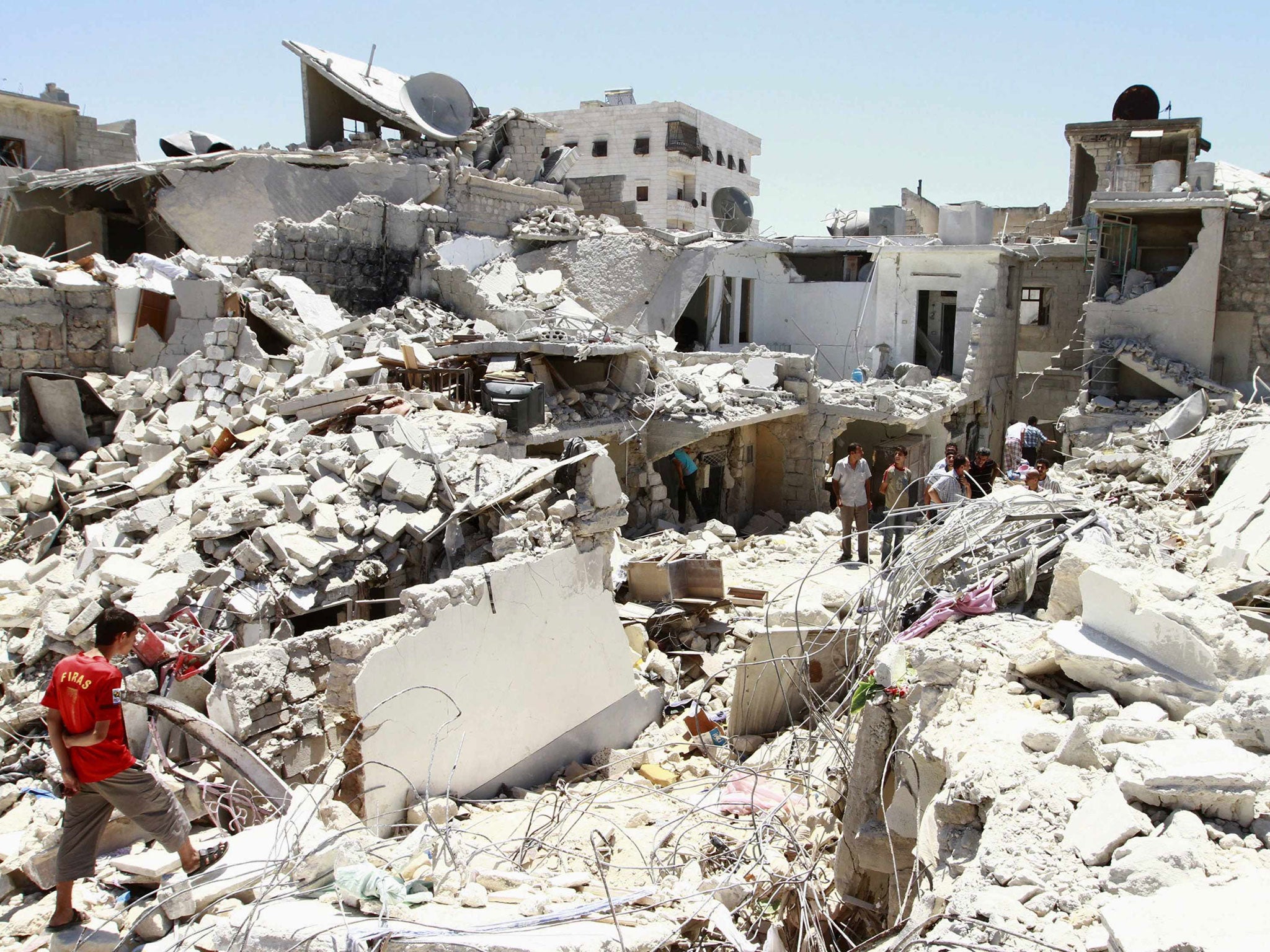 Residents rummage through the damage and debris left of their homes for their belongings