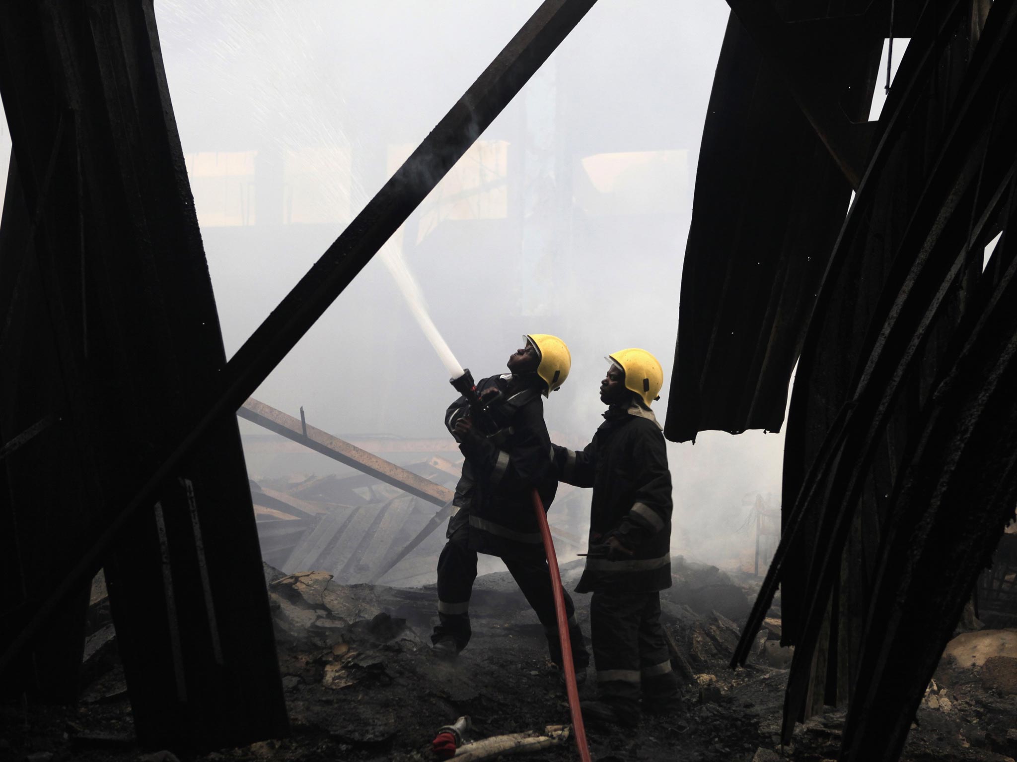 Fire fighters struggle to put out a fire at the Jomo Kenyatta International Airport