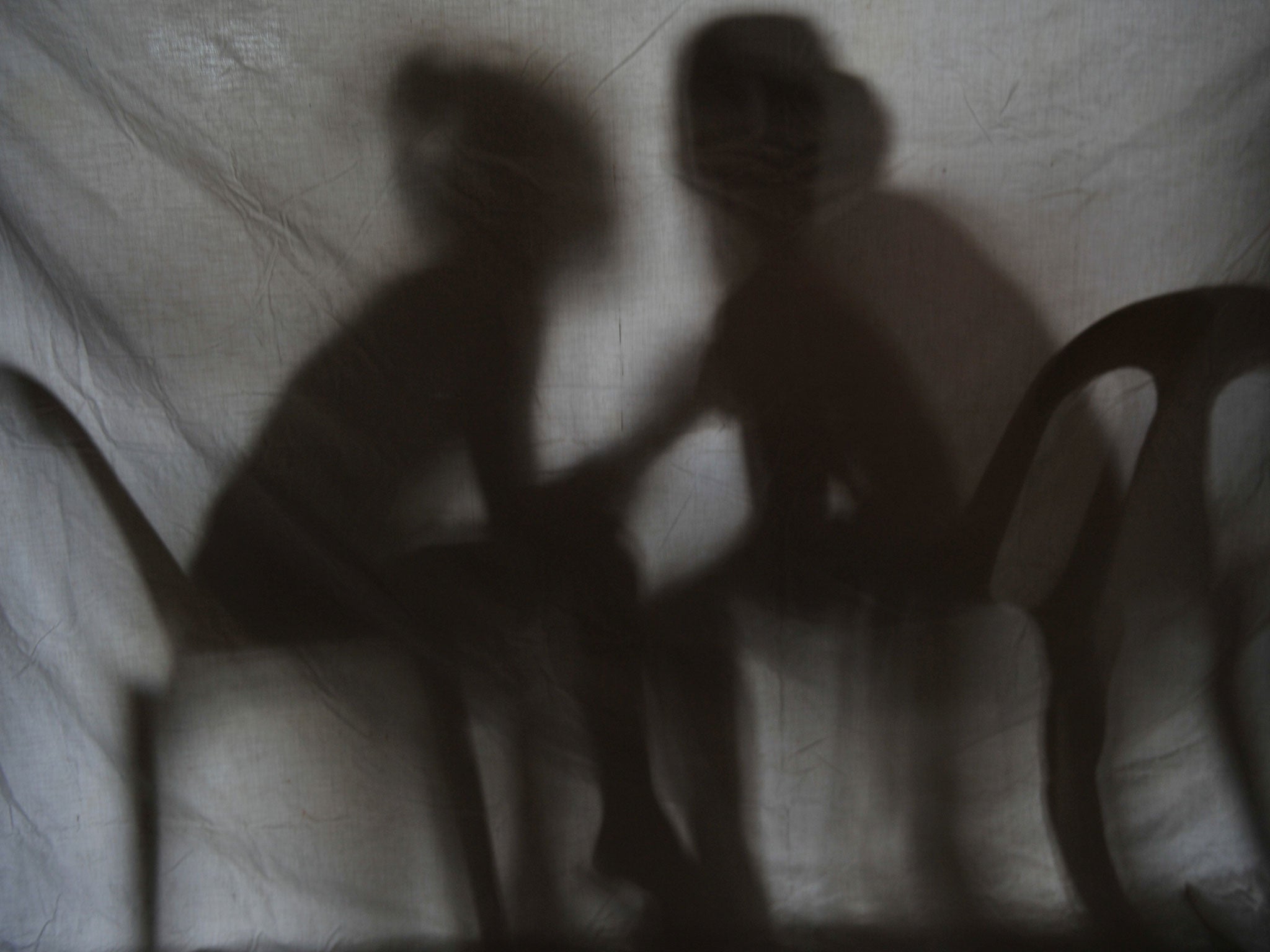 The shadow of two teenage girls rescued from a cyber sex den is seen in this photo taken at Preda Foundation office on December 2, 2010 in Olongapo City, Zambales province, north of Manila.