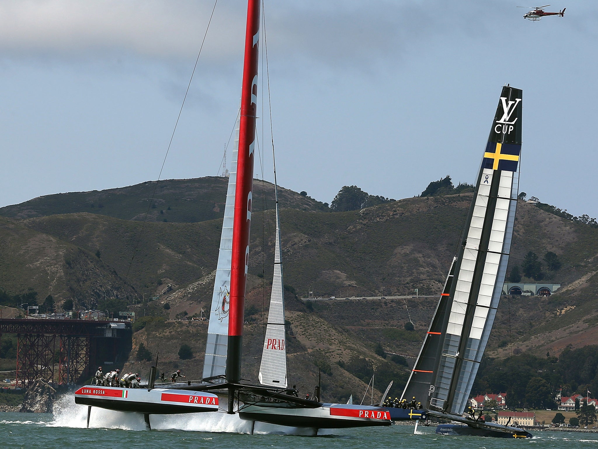 Team Luna Rossa Challenge (L) is skippered by Massimiliano Sirena against Team Artemis Racing (R) skippered by Iain Percy during race three of the Louis Vuitton Cup