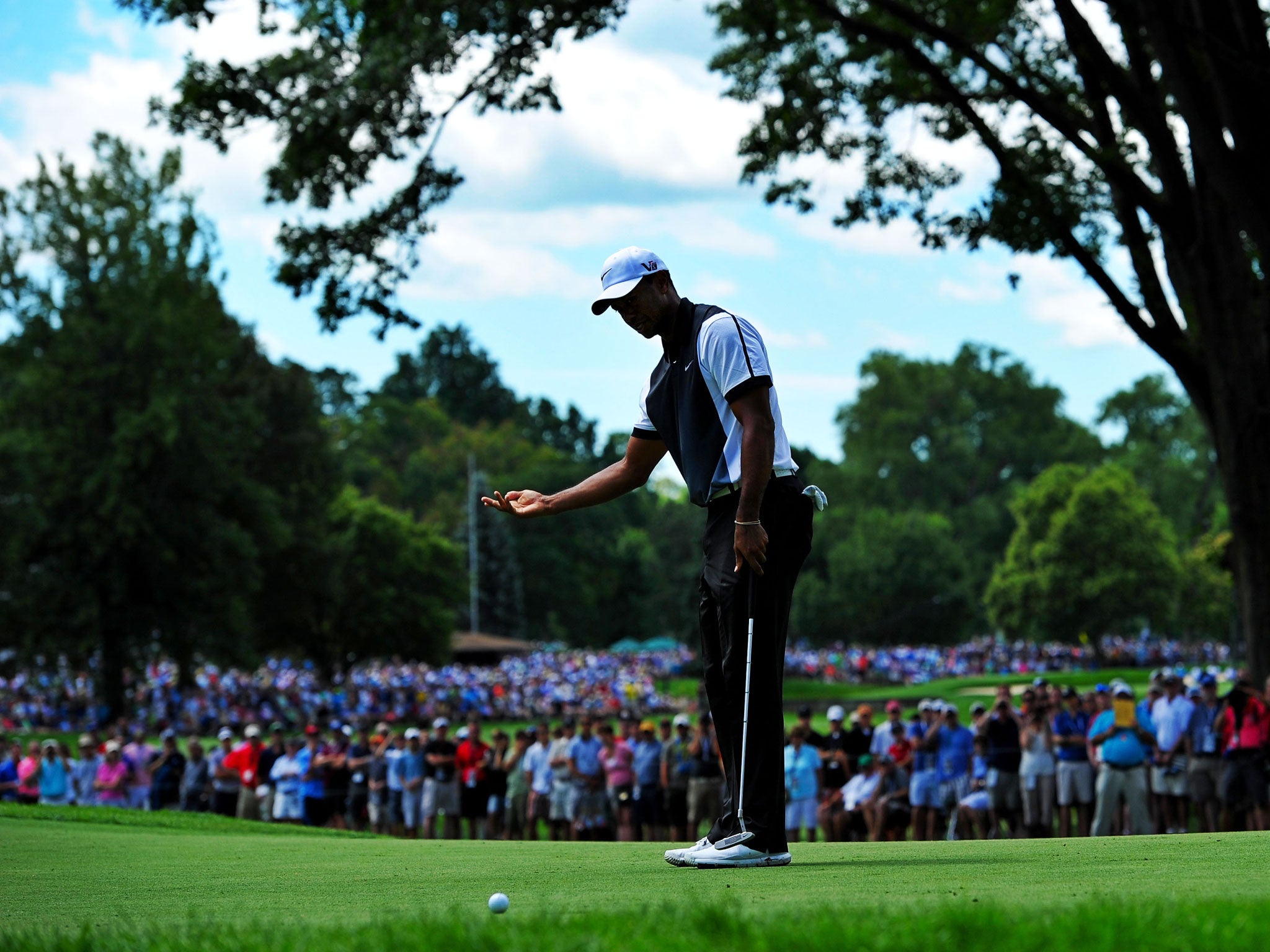 Tiger Woods reacts to a missed putt on the fourth green during his third round at Oak Hill