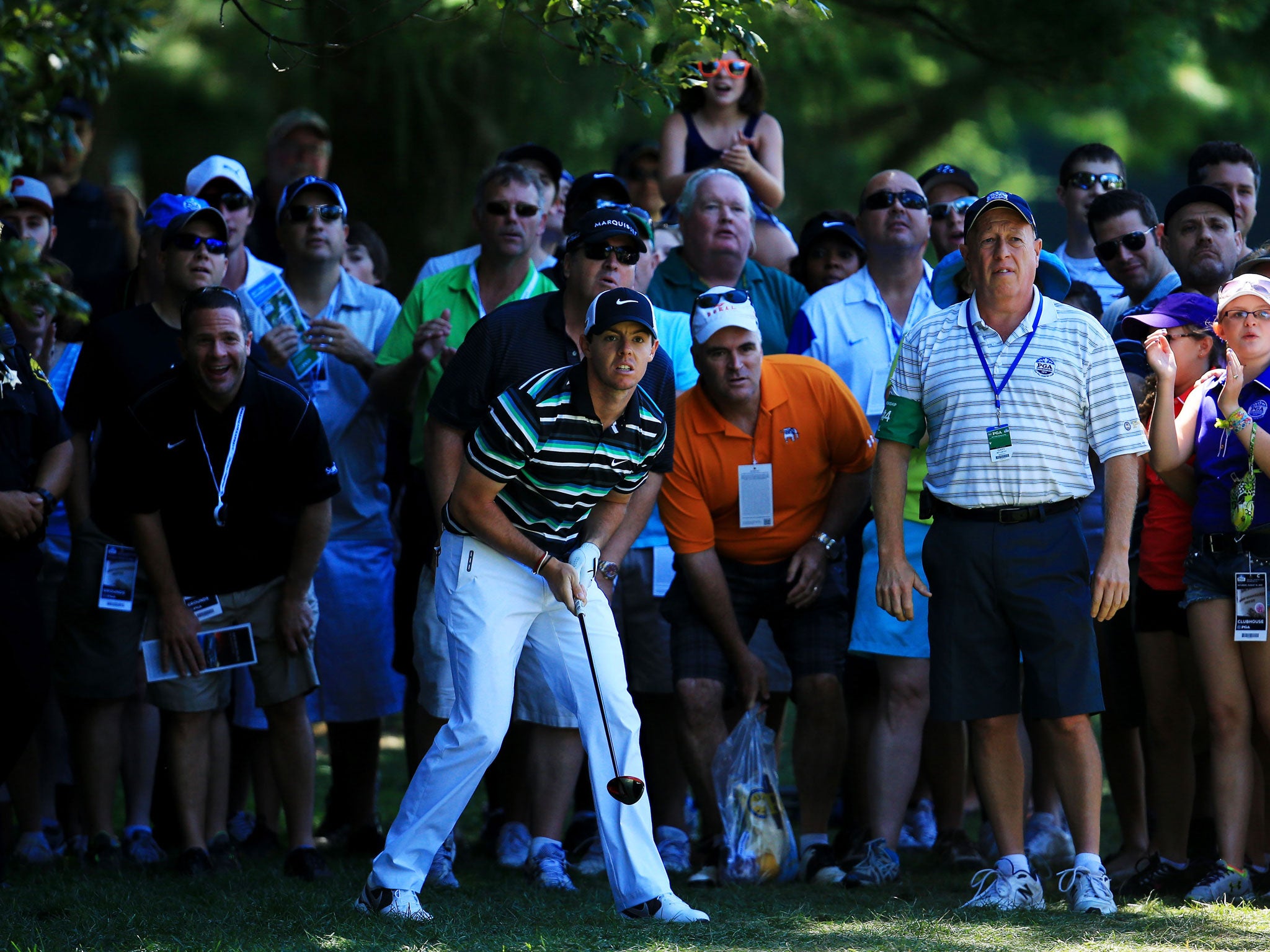 Rory McIlroy watches anxiously after playing out of the rough on the fourth hole