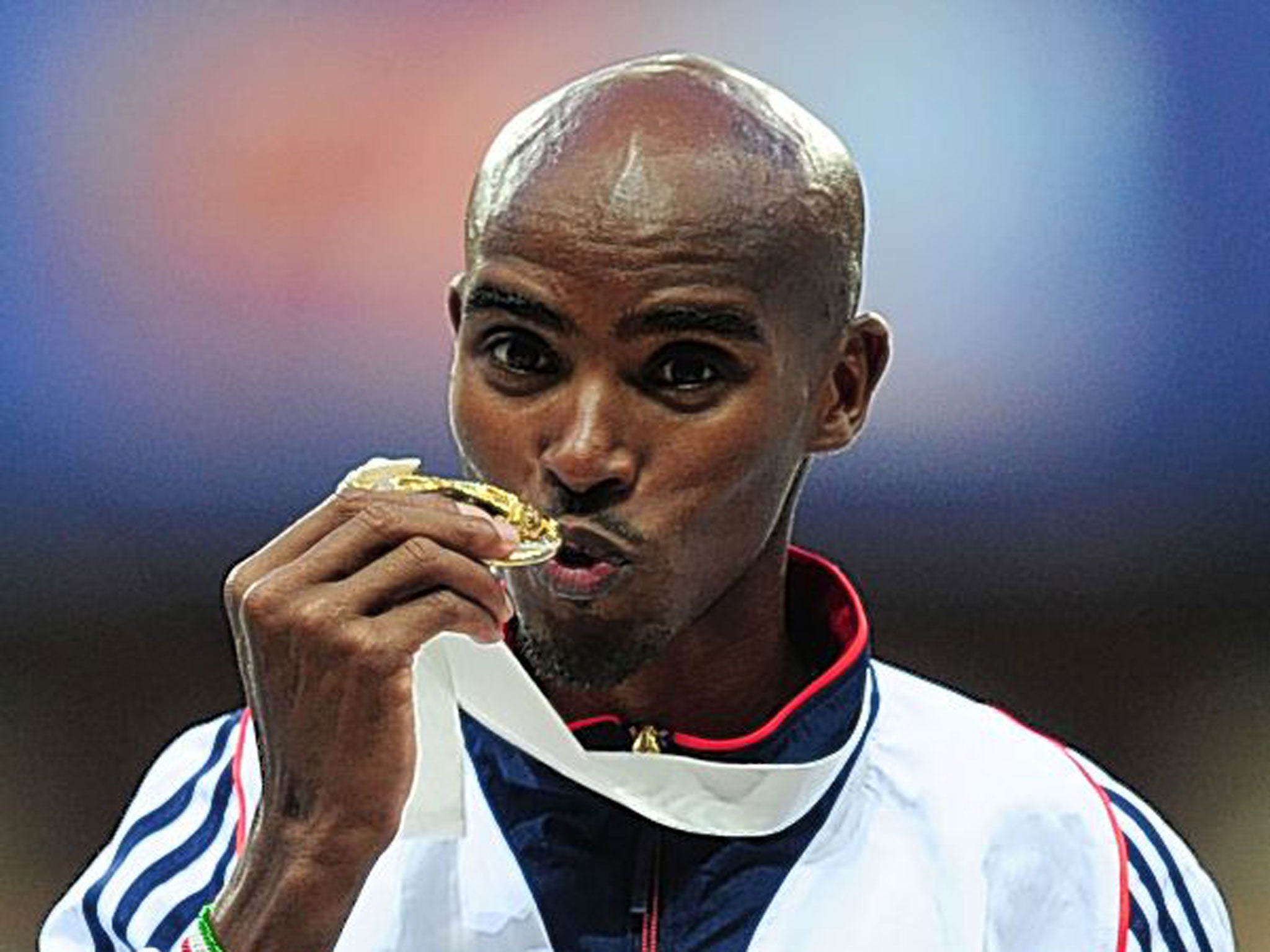 Mo Farah kisses his 10,000m gold medal following his victory on Saturday