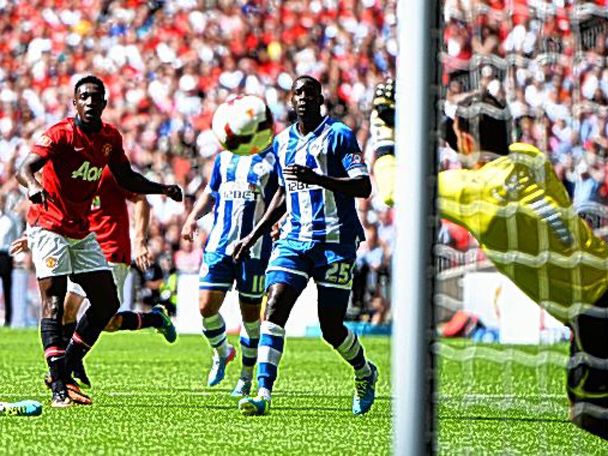 Scott Carson, of Wigan, reacts well to deny Danny Welbeck