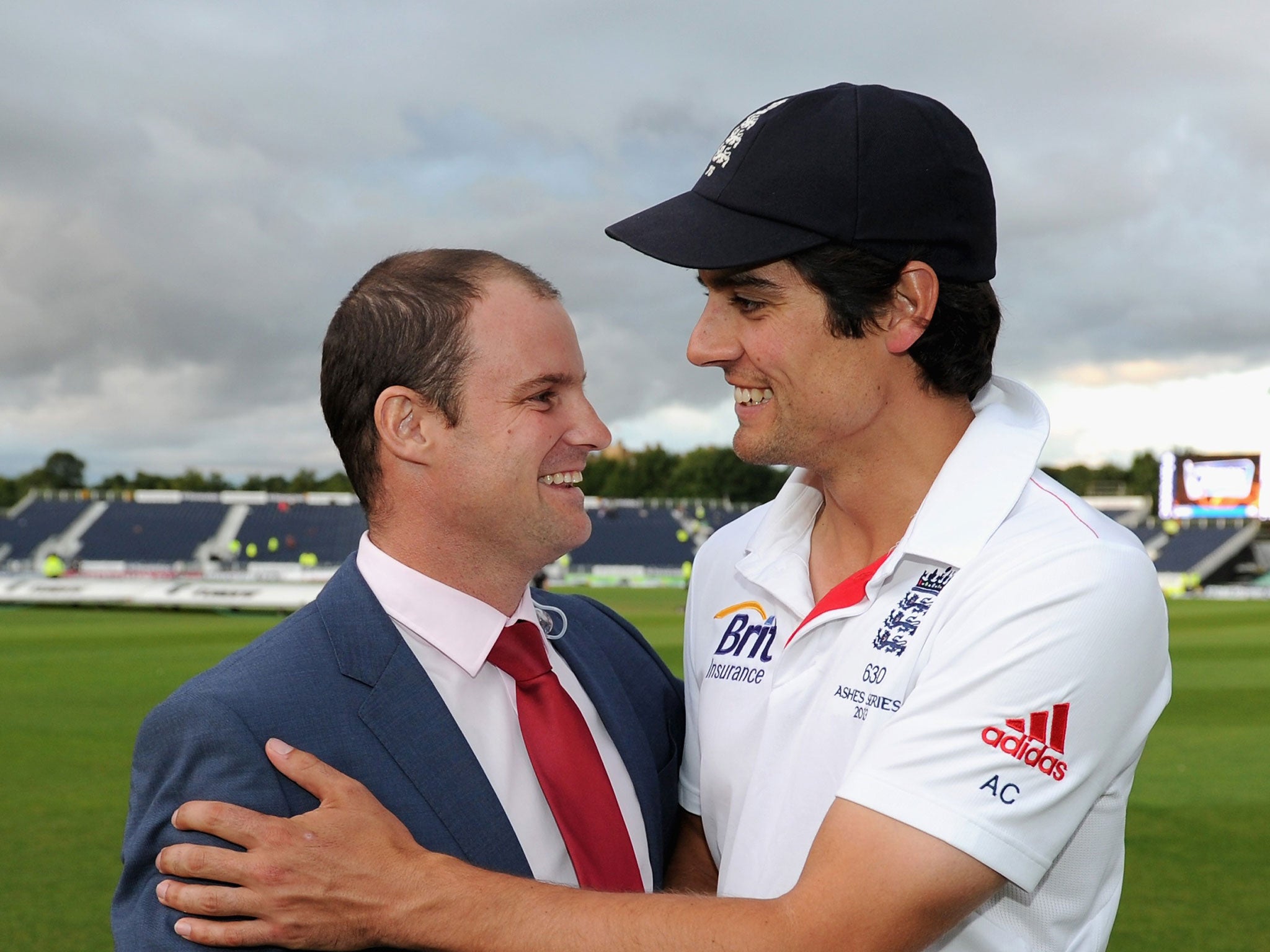 England captain Alastair Cook celebrates with former skipper Andrew Strauss