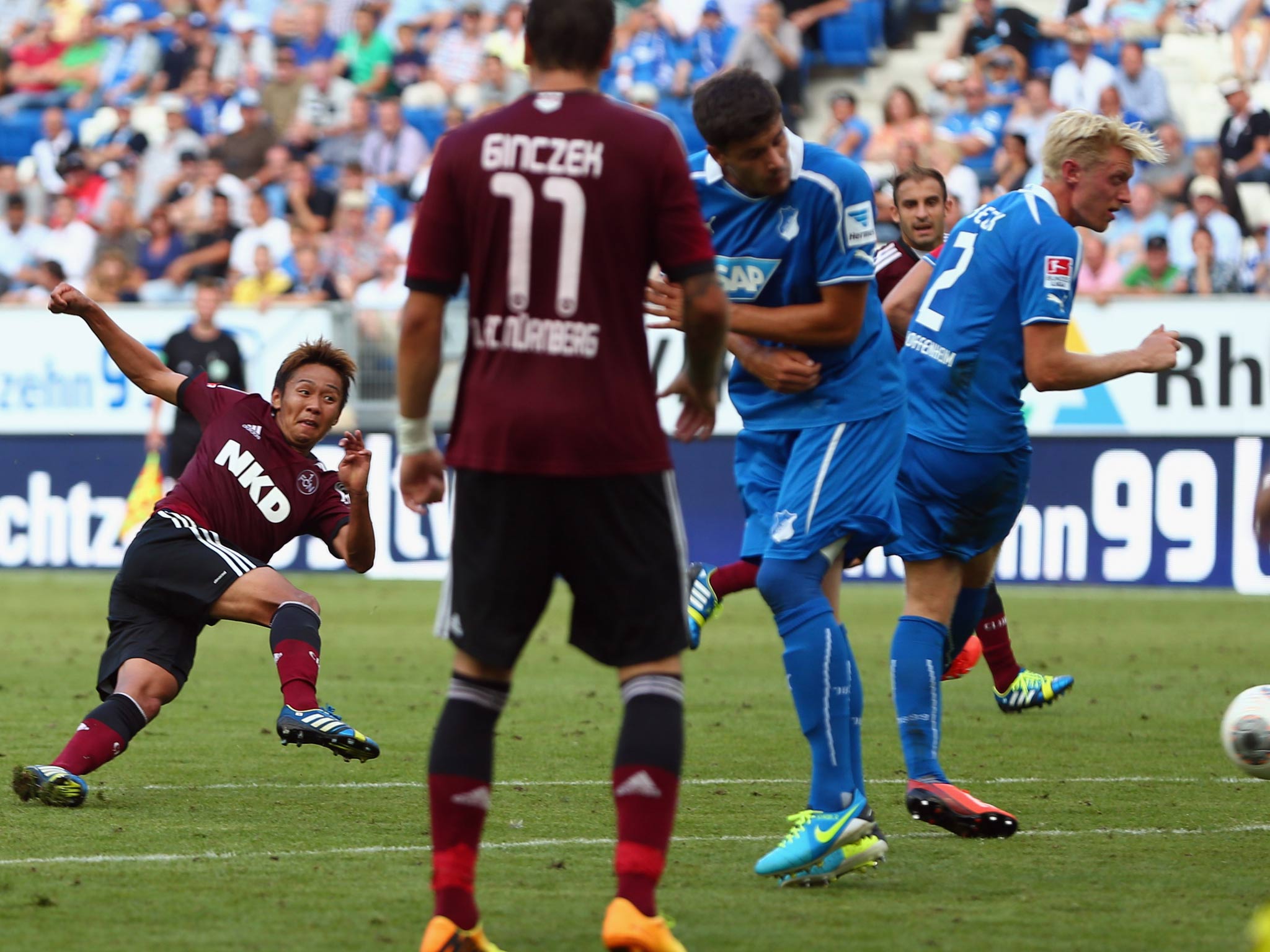 Hiroshi Kiyotake (L) of Nuernberg tries to score during the Bundesliga match between 1899 Hoffenheim and 1. FC Nuernberg