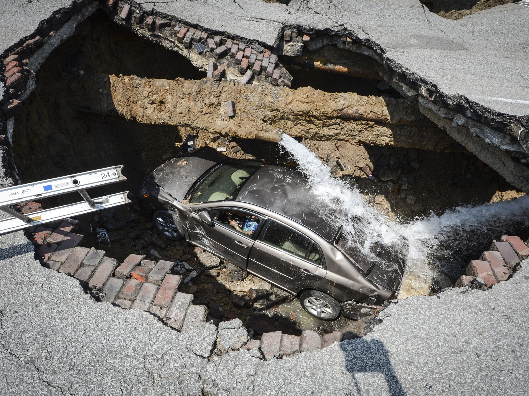 A car after being sucked into a sinkhole in Toledo, Ohio, in July