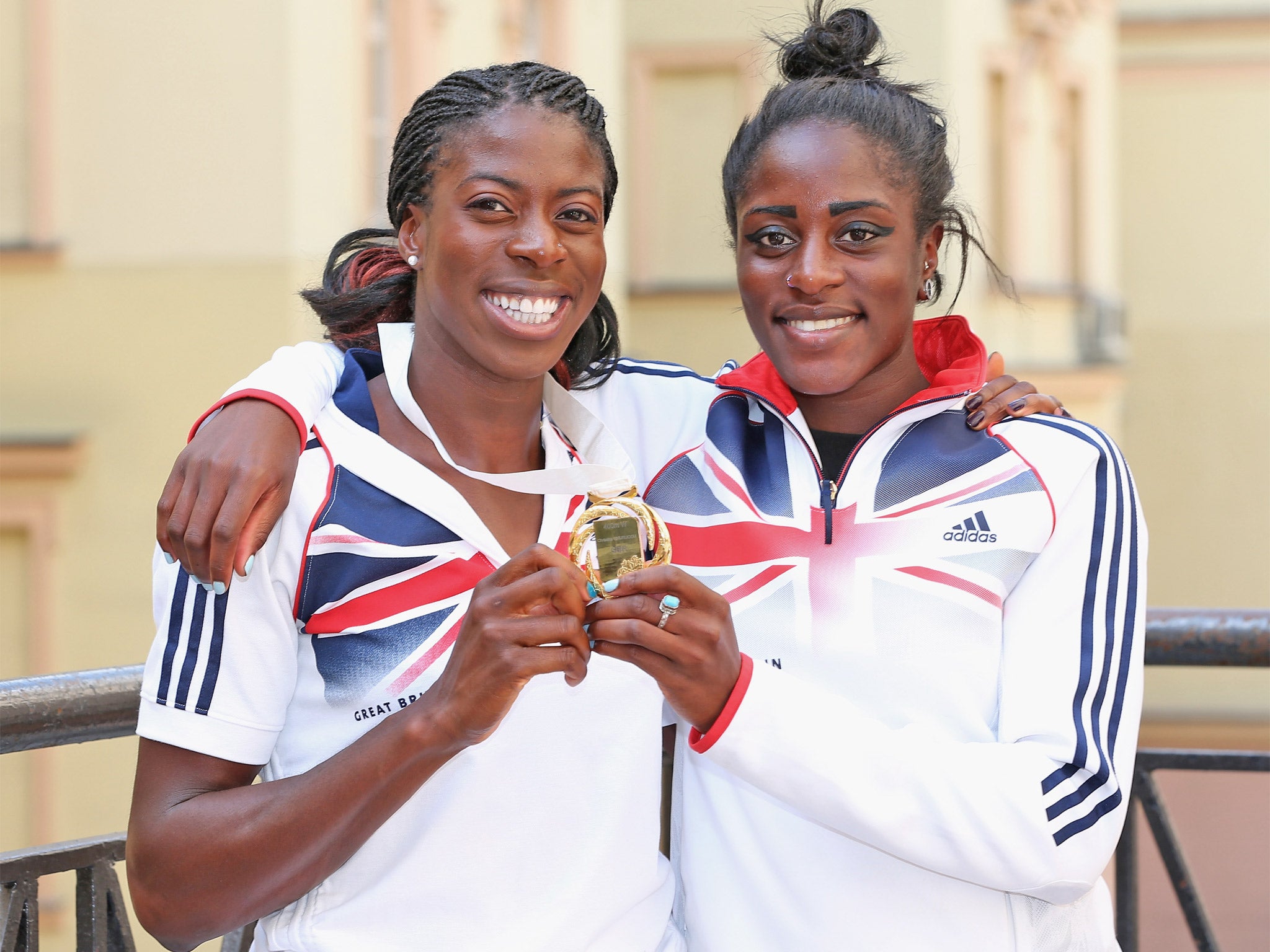 Christine Ohuruogu (left) poses yesterday with her gold medal and sister Vicky, who is part of the relay squad in Moscow