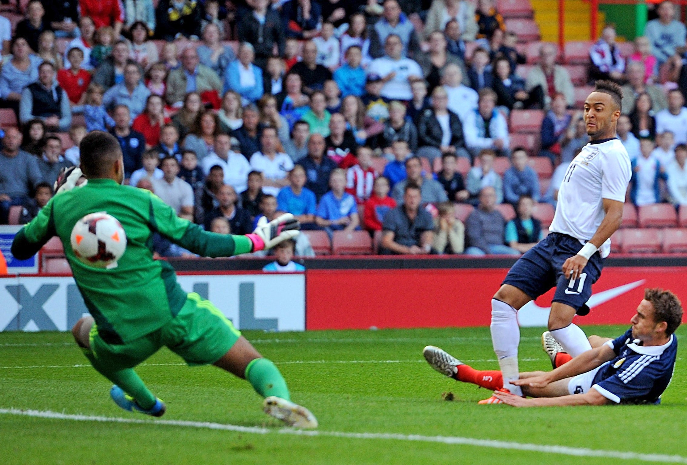 Nathan Redmond beats Jordan Archer to score the first of England Under-21s’ six goals against Scotland at Bramall Lane