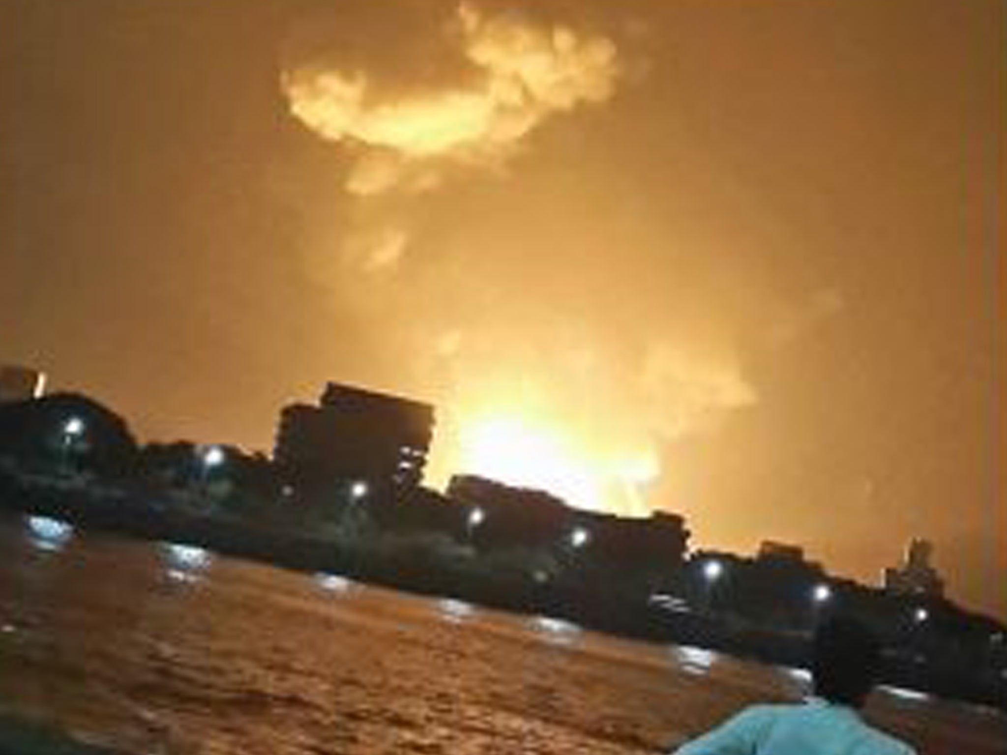 A man watches Indian Navy submarine INS Sindhurakshak on fire in Mumbai