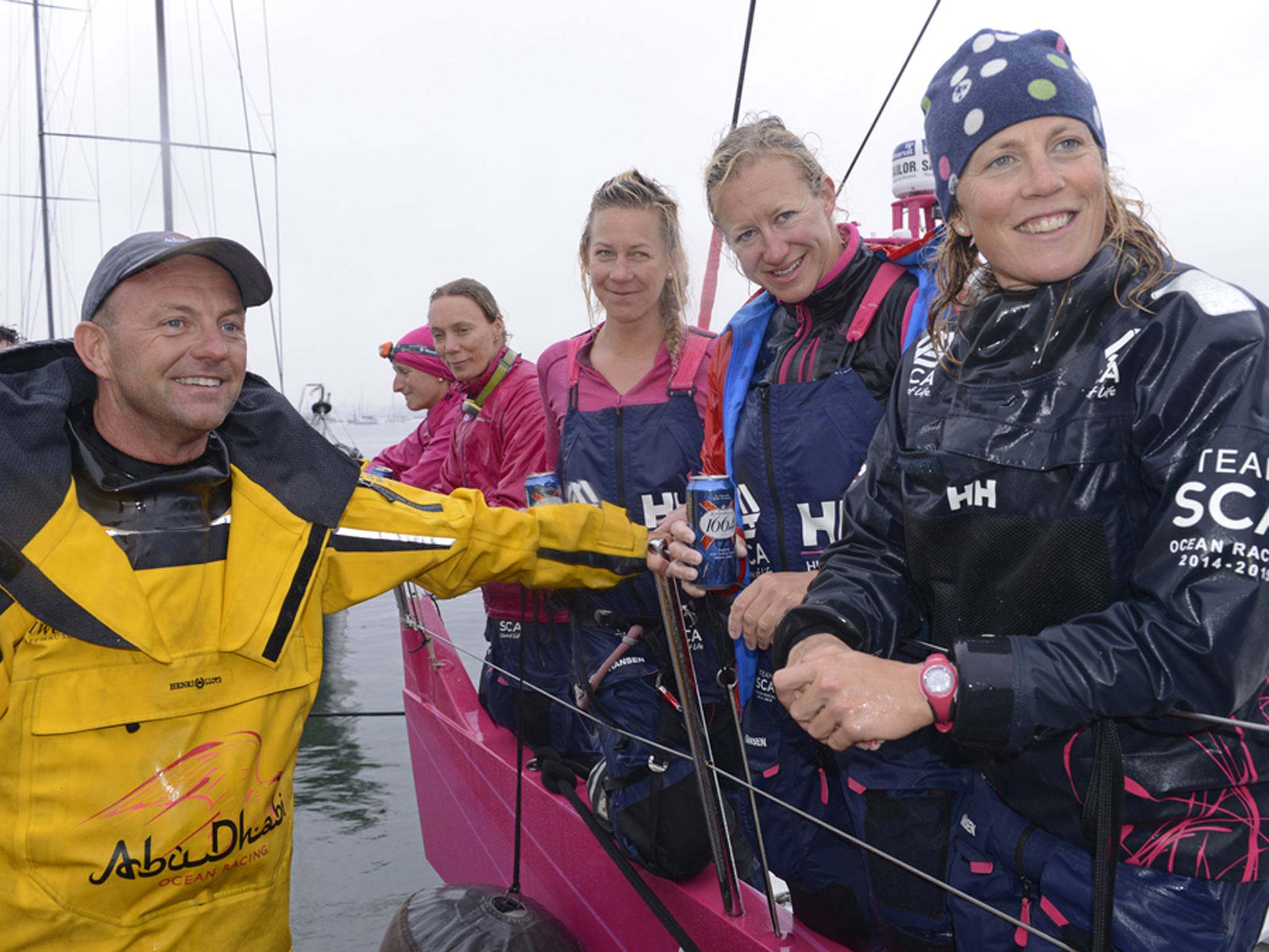 Honours nearly even for the two Volvo 70s in their Rolex Fastnet Race head to head as Abu Dhabi skipper Ian Walker (GBR left), first home, greets Sam Davies (GBR right) ahead on handicap in the Swedish Team SCA. Pictured centre, left to right, are Sarah L