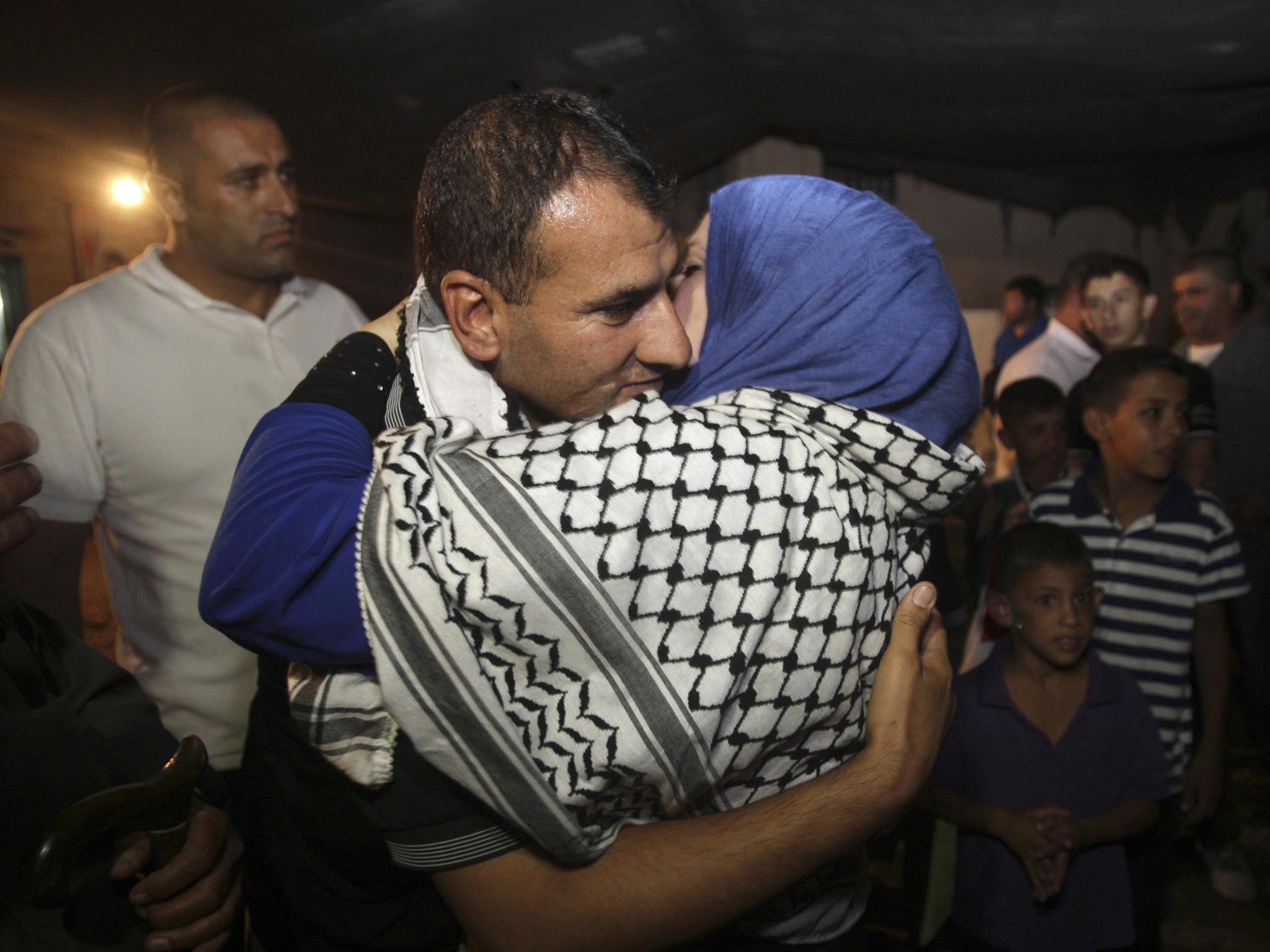 Released Palestinian prisoner Hosni Sawalha is hugged by a relative