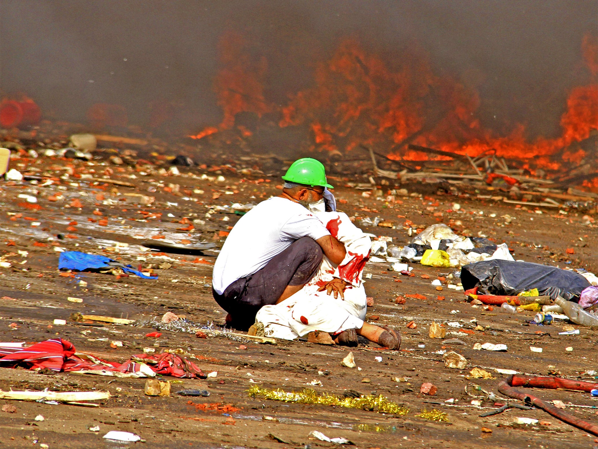 A protester comforts a wounded colleague